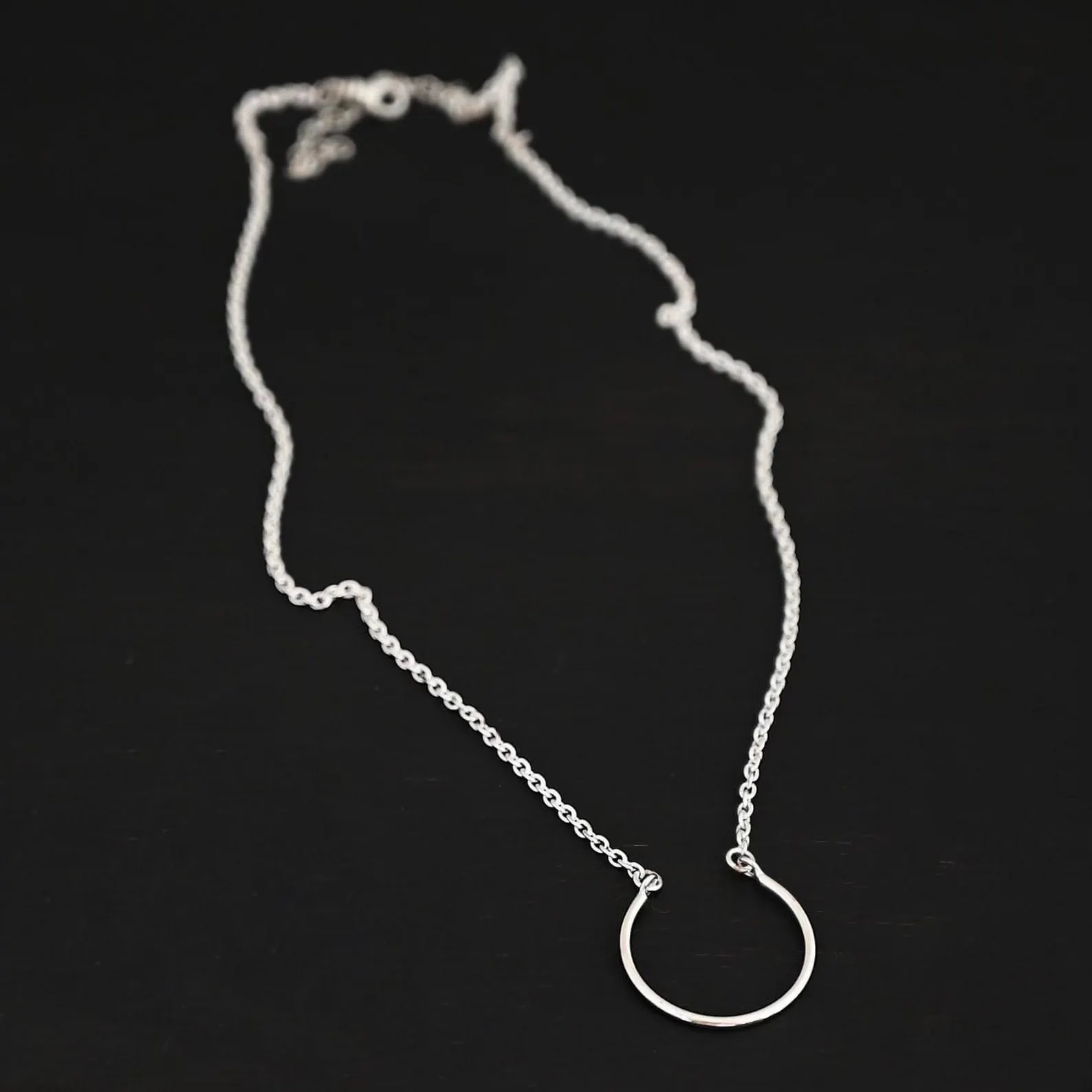 Claire Charm Necklace shown on dark background