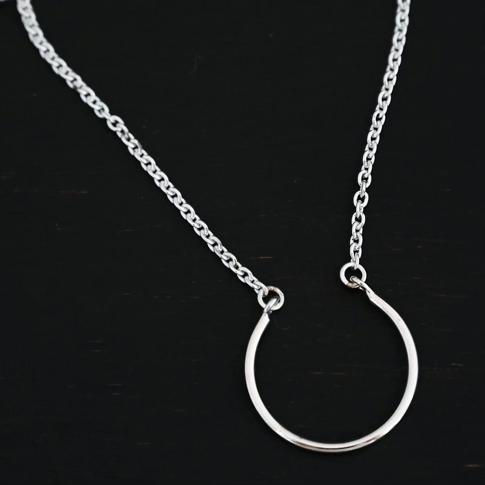 Claire Charm Necklace shown on dark background