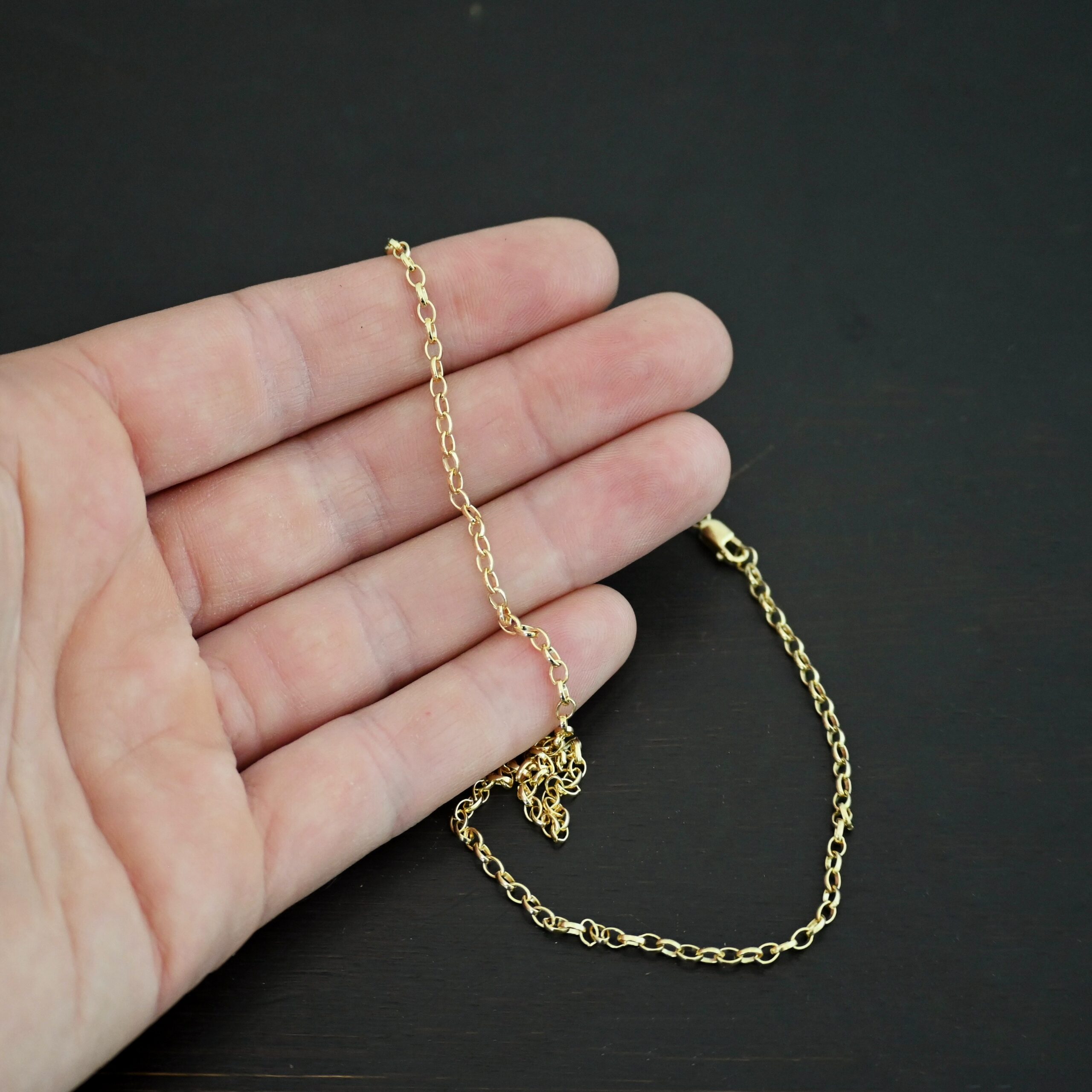 14k gold filled Ruby Rolo Chain shown in hand