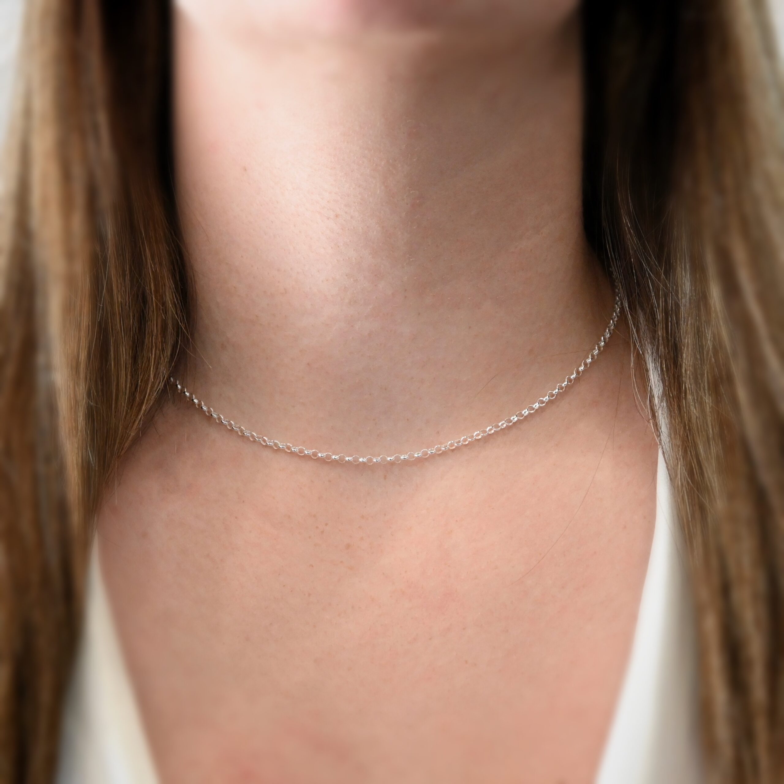 Rachel Rolo Chain - 16-18" shiny Sterling Silver Rachel Rolo - 16-18" shiny shown on model with white shirt and brown hair