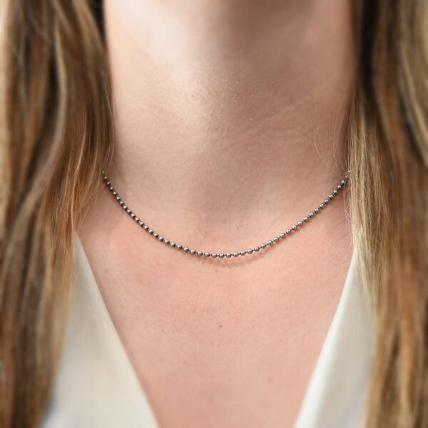 Stainless Steel Beau Ball Chain - 2.4mm 16-18" shown on model with white shirt and brown hair