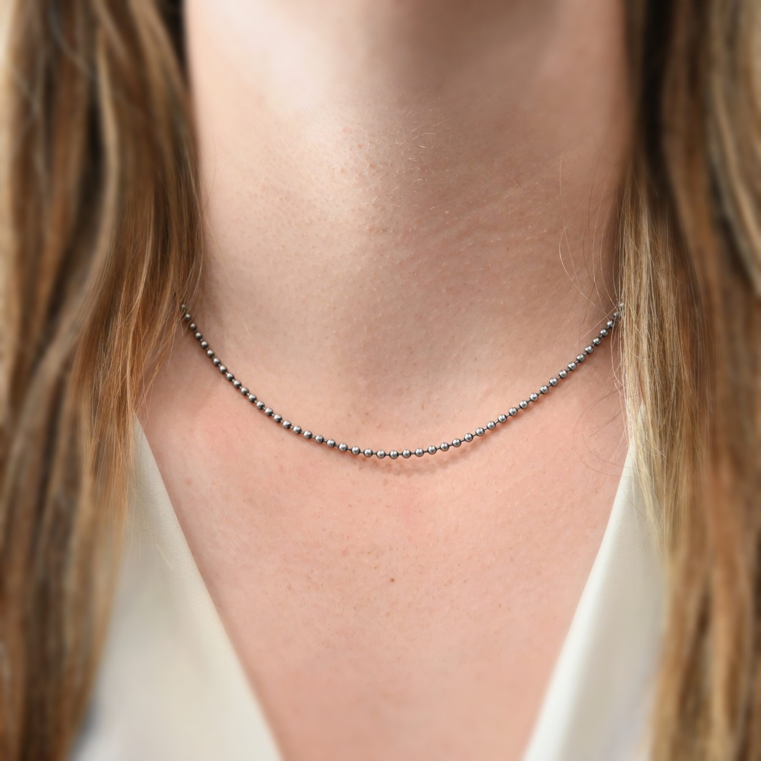 Stainless Steel Beau Ball Chain - 2.4mm 16-18" shown on model with white shirt and brown hair