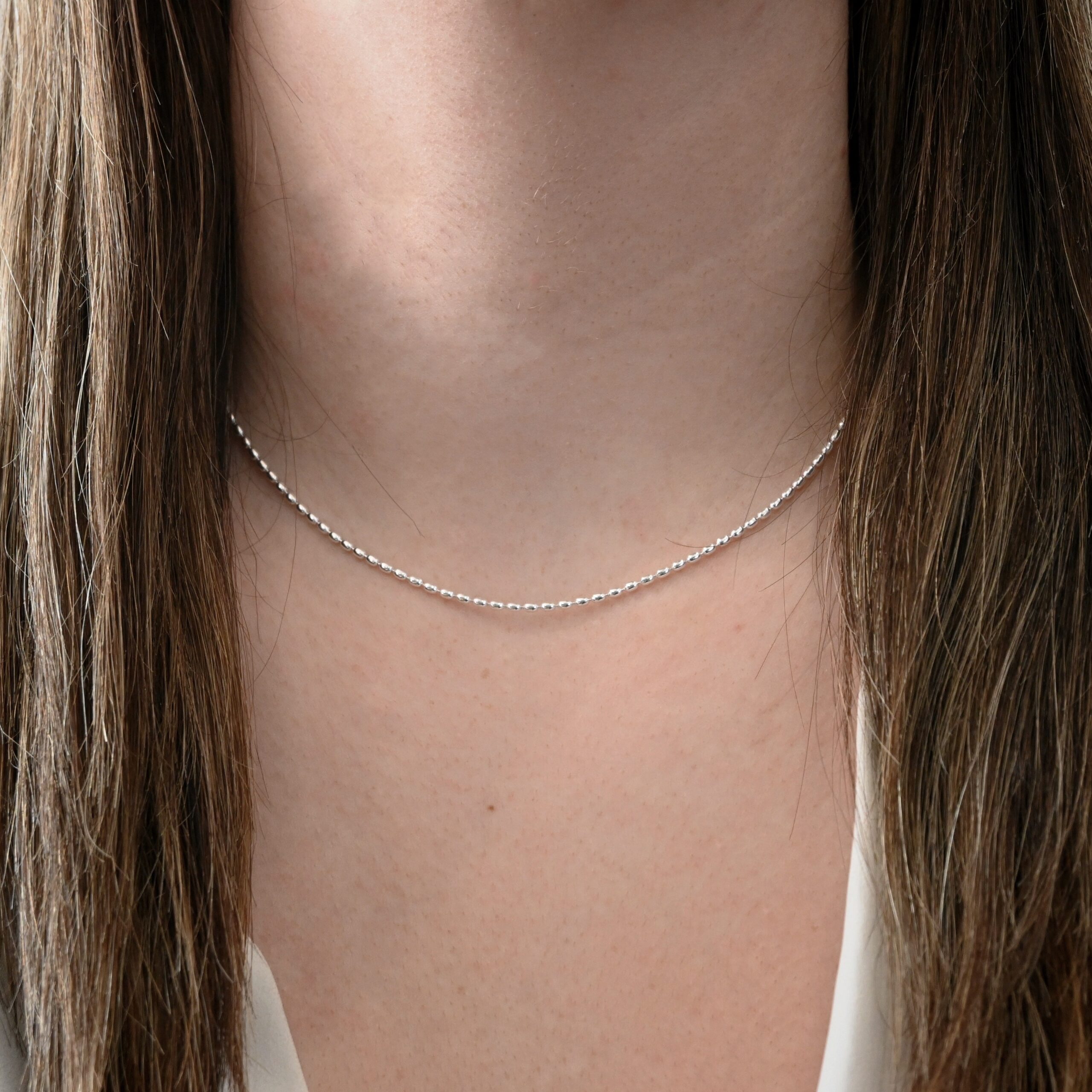 Bryn Beaded Chain 1.5mm 16-18" Shiny shown on model with white shirt and brown hair