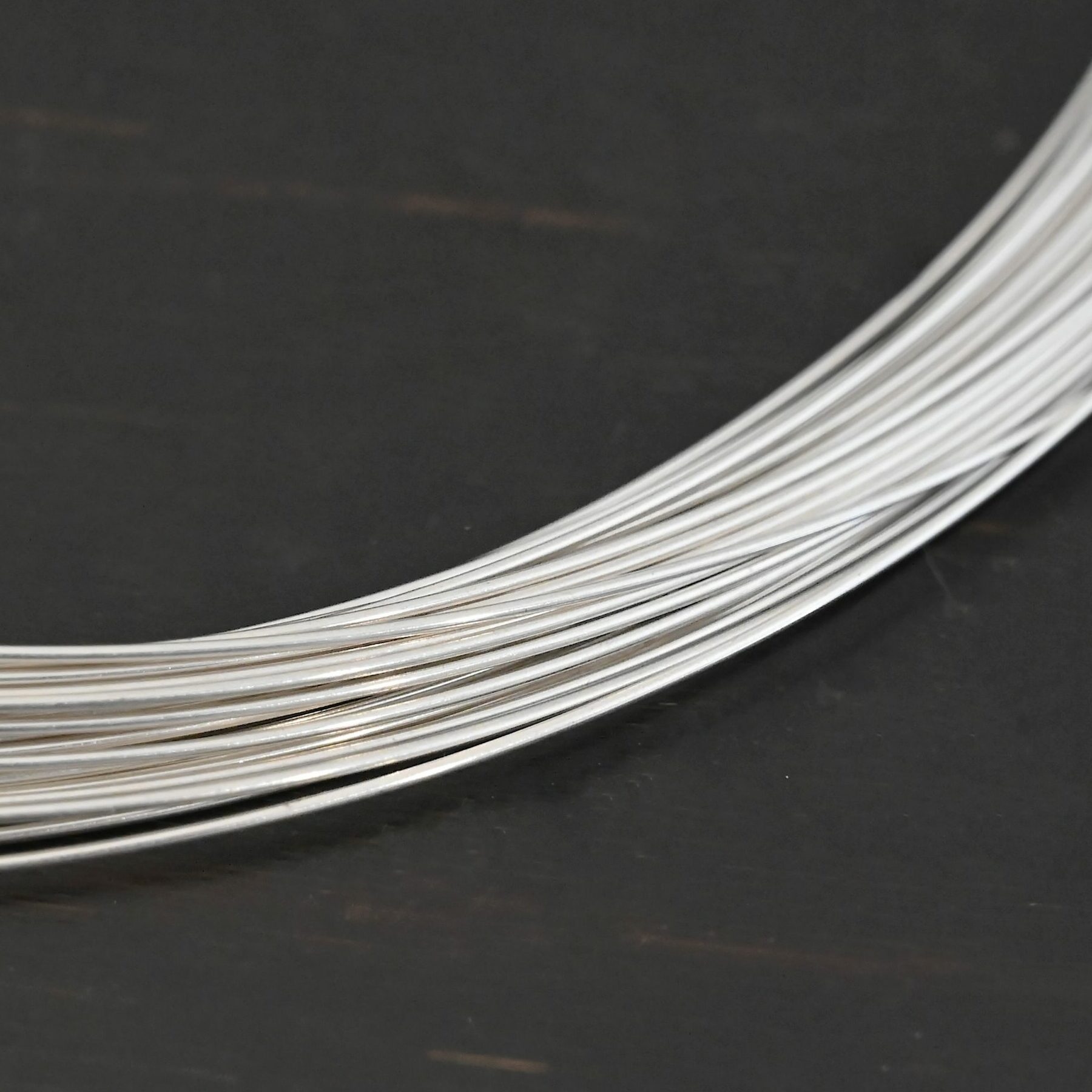Silver Round Wire shown on dark background