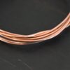 Copper Round Wire shown on dark background