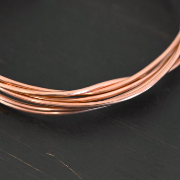 Copper Round Wire shown on dark background