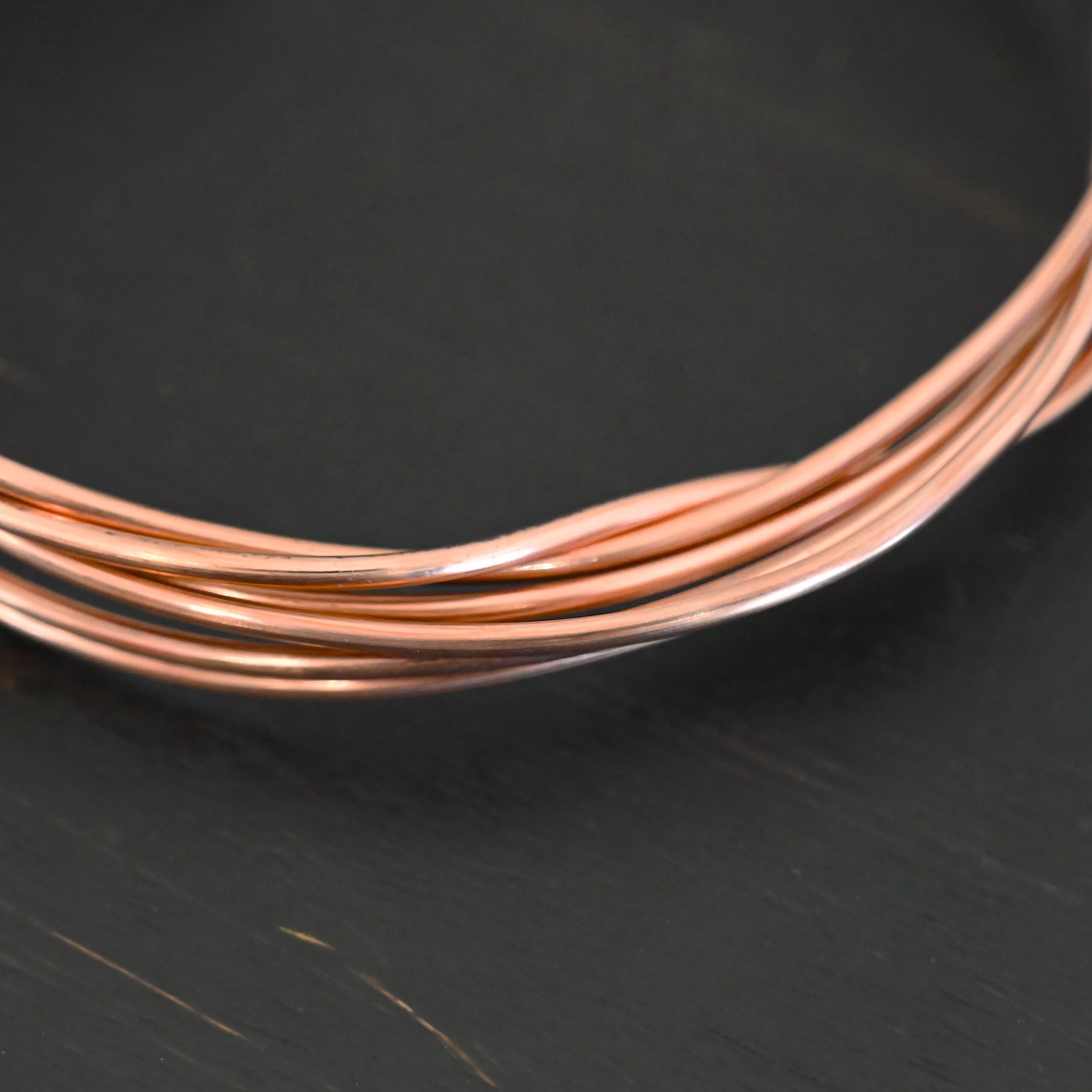 Copper Round Wire Copper Round Wire shown on dark background