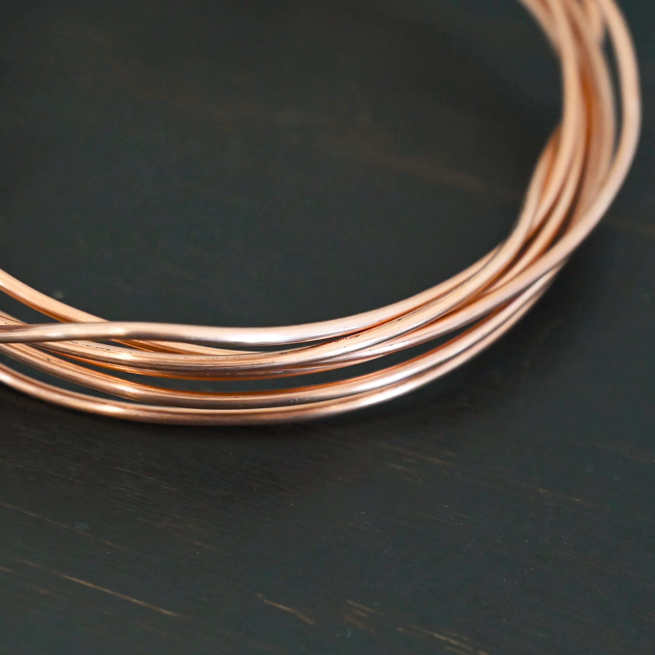 Copper Round Wire Copper Round Wire shown on dark background