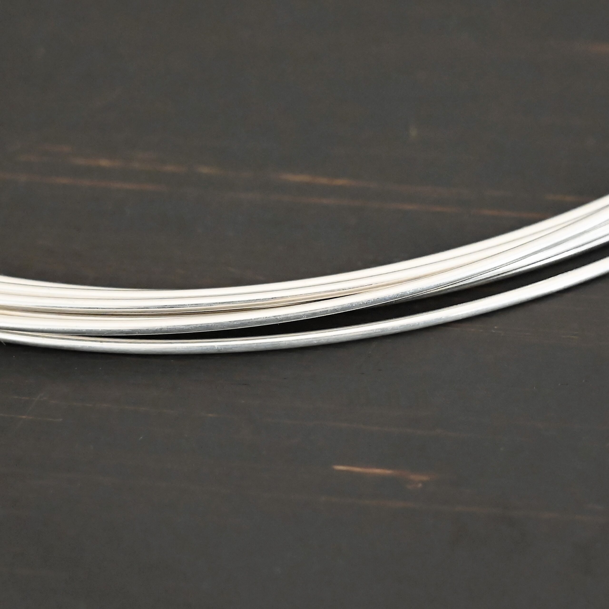 Silver Round Wire shown on dark background