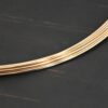 Gold Filled Round Wire shown on dark background