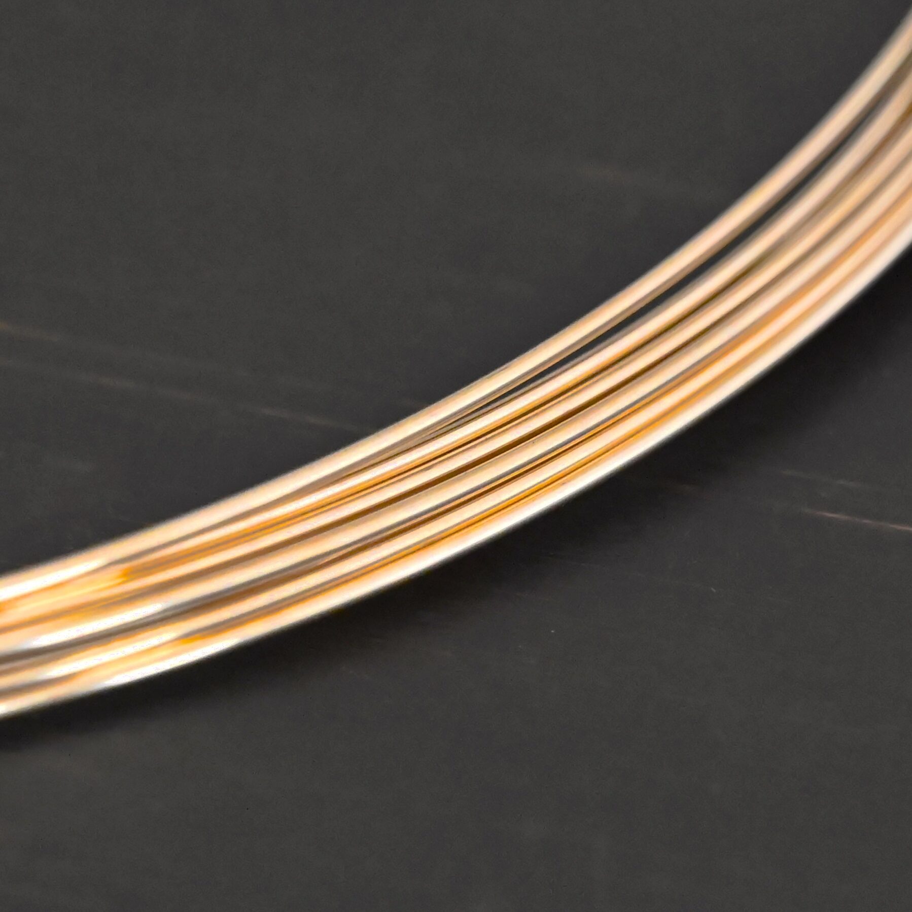 Gold Filled Round Wire shown on dark background
