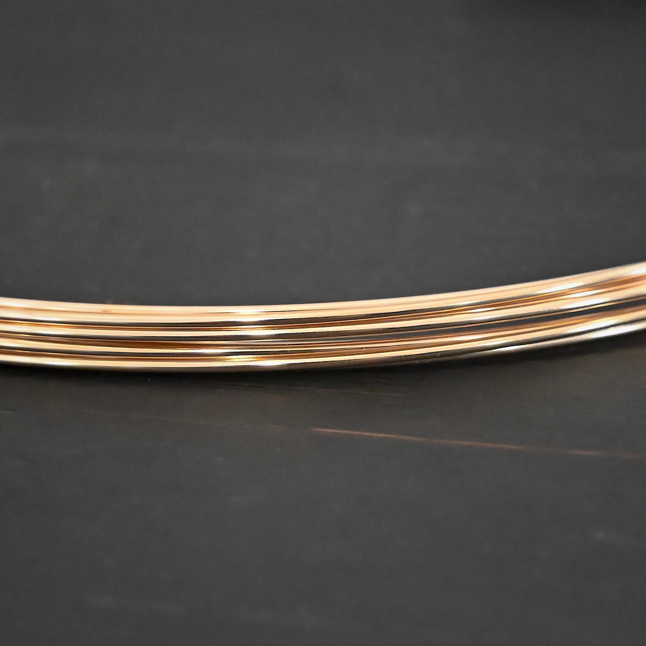 Gold Filled Round Wire shown on dark background