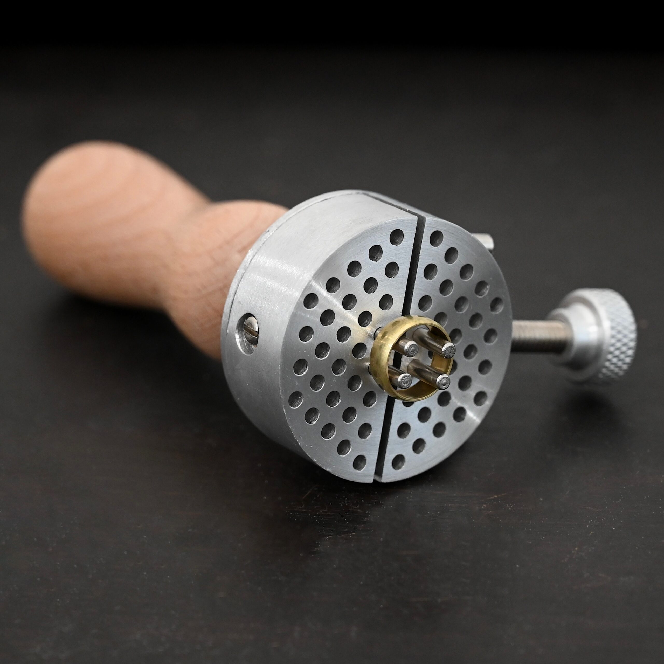 Wire jig Tool stainless steel and wooden handle shown on dark background