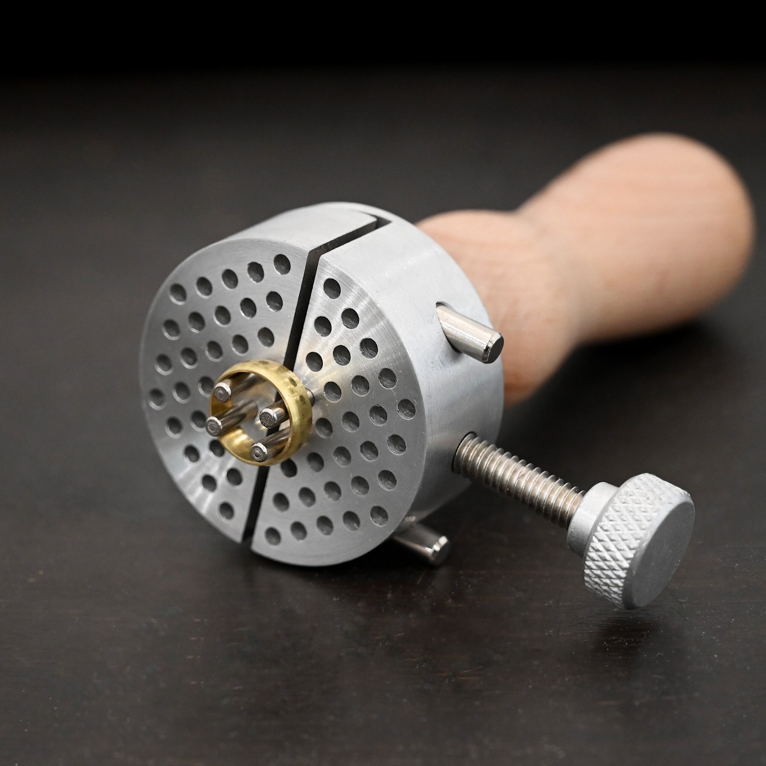 Wire jig Tool stainless steel and wooden handle shown on dark background