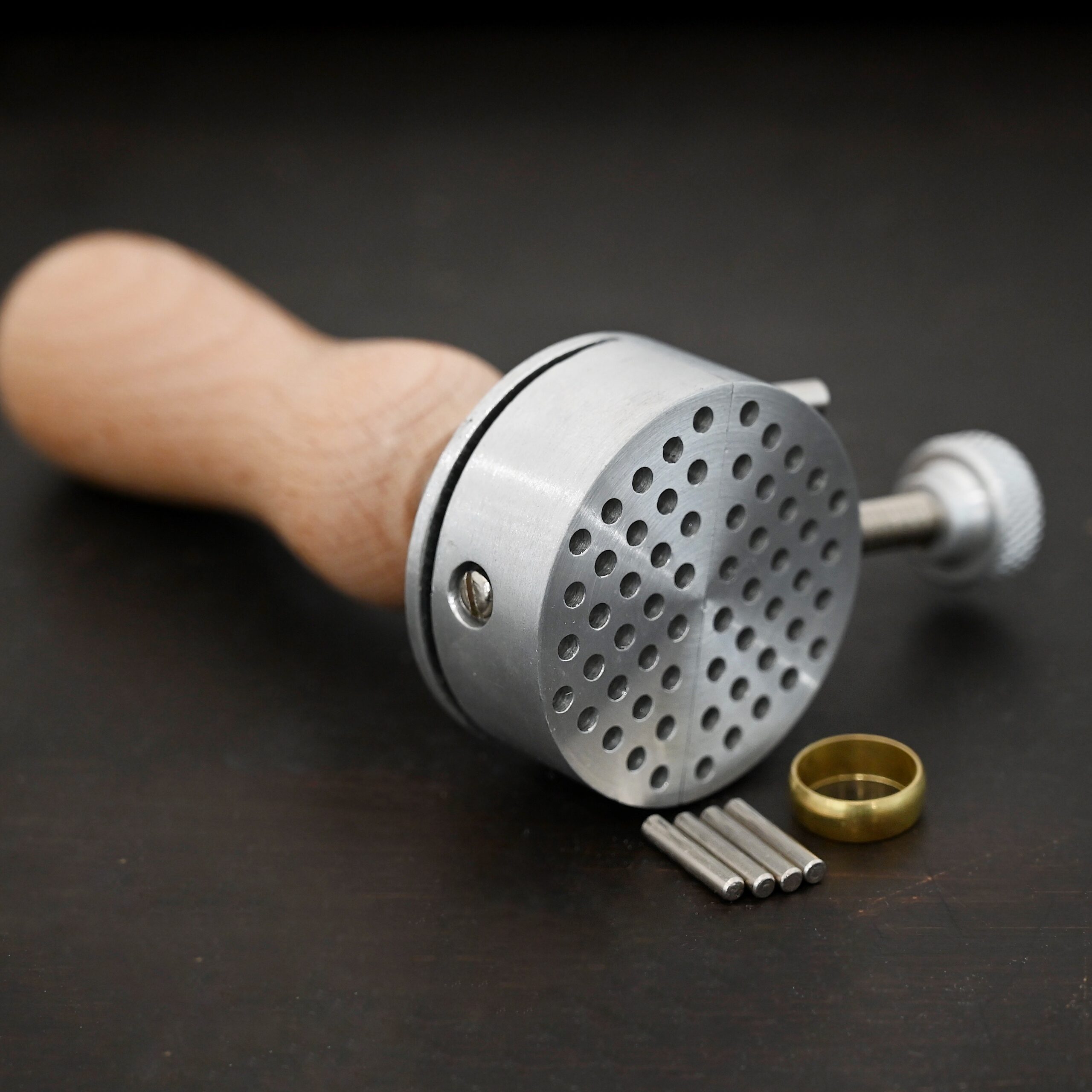 Wire jig Tool stainless steel and wooden handle shown on dark background