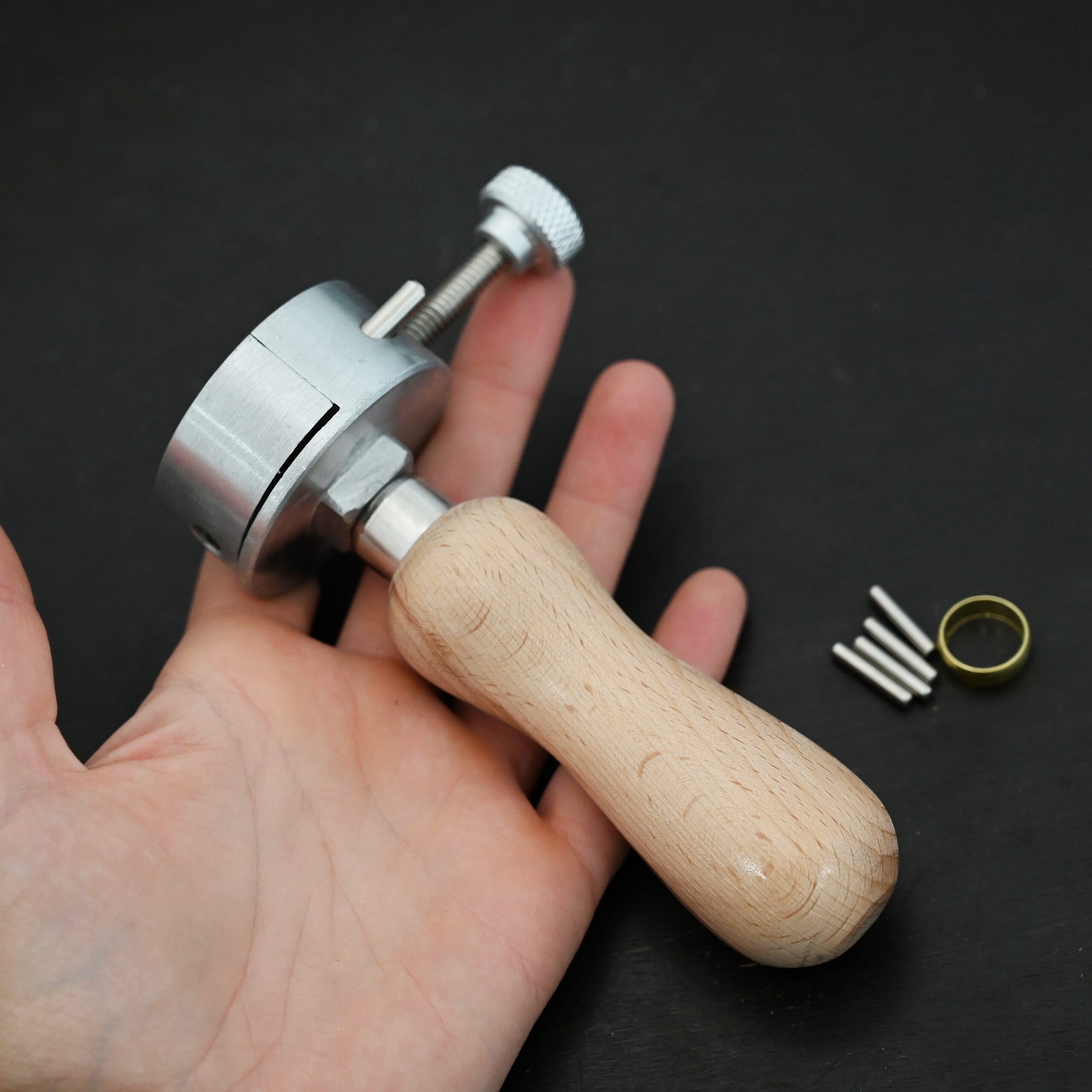 Wire jig Tool stainless steel and wooden handle shown in hand