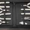 Shows entire set of tools in its tool bag - 7 pliers total with white foam handles in black nylon bag