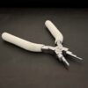 Double Stepped Mandrel included in kit - stainless steel and white foam handle shown on dark background