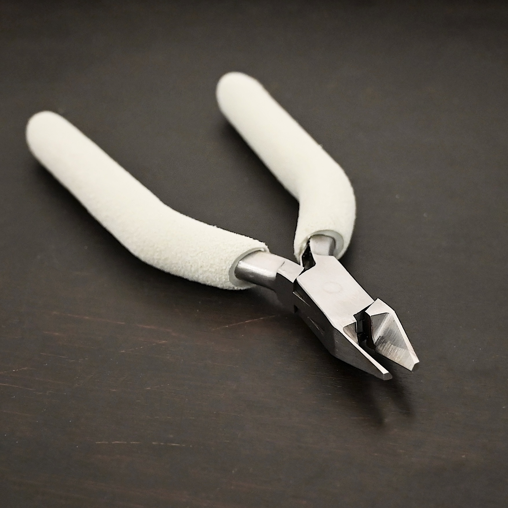 Cutting Pliers included in kit - stainless steel and white foam handle shown on dark background