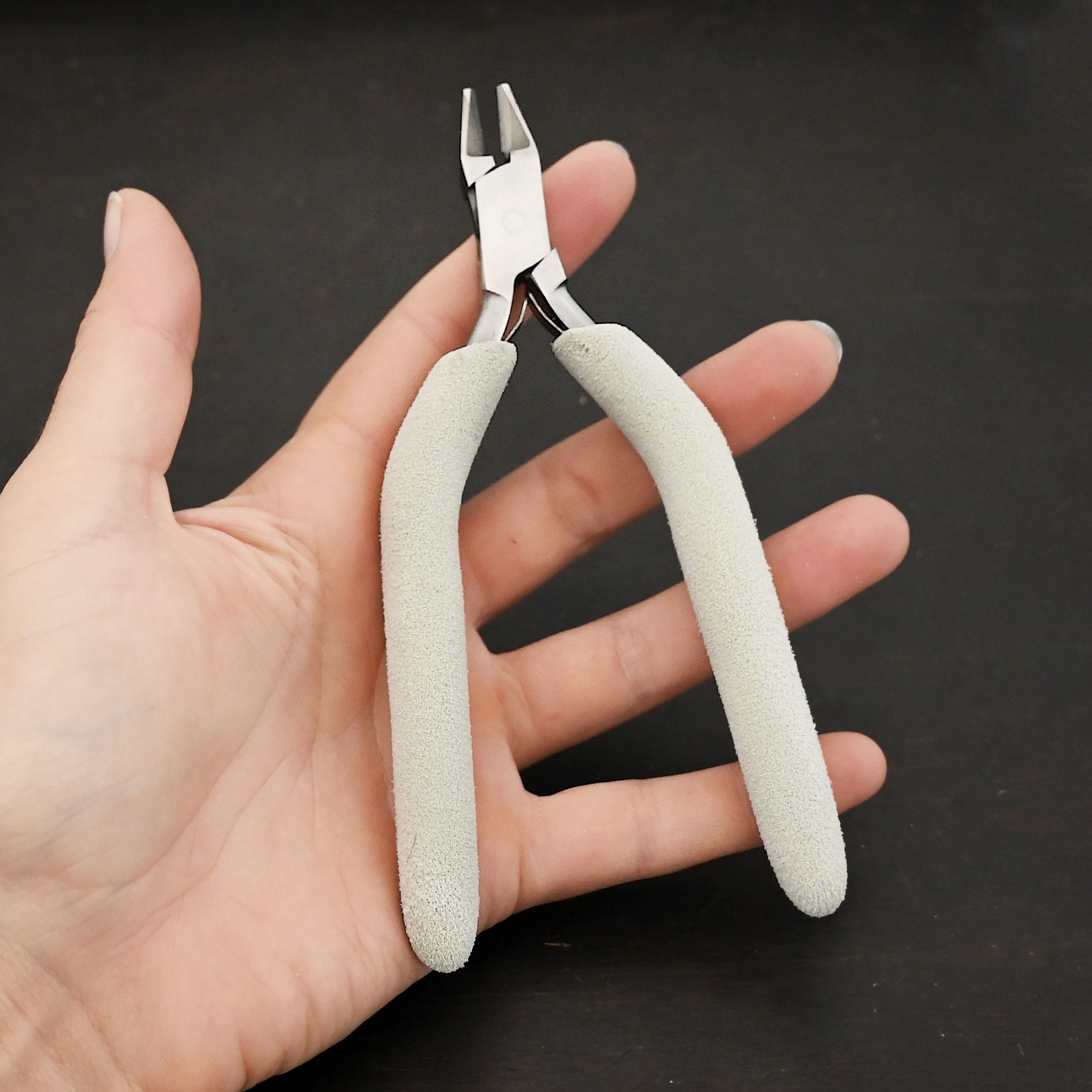 Cutting Pliers included in kit - stainless steel and white foam handle shown in hand