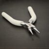 Double Wire Wrapping Pliers included in kit - stainless steel and white foam handle shown on dark background