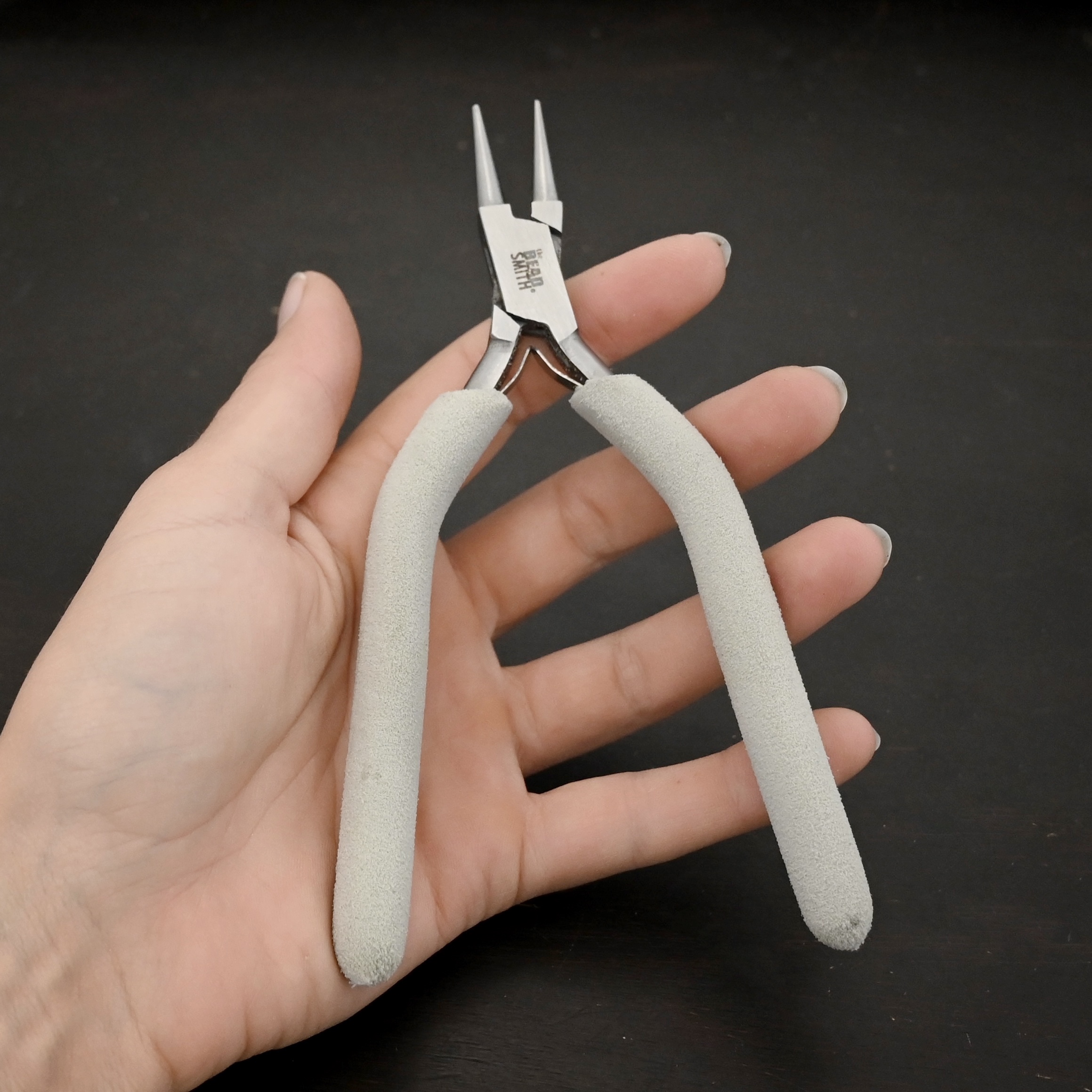 Double Wire Wrapping Pliers included in kit - stainless steel and white foam handle shown in hand