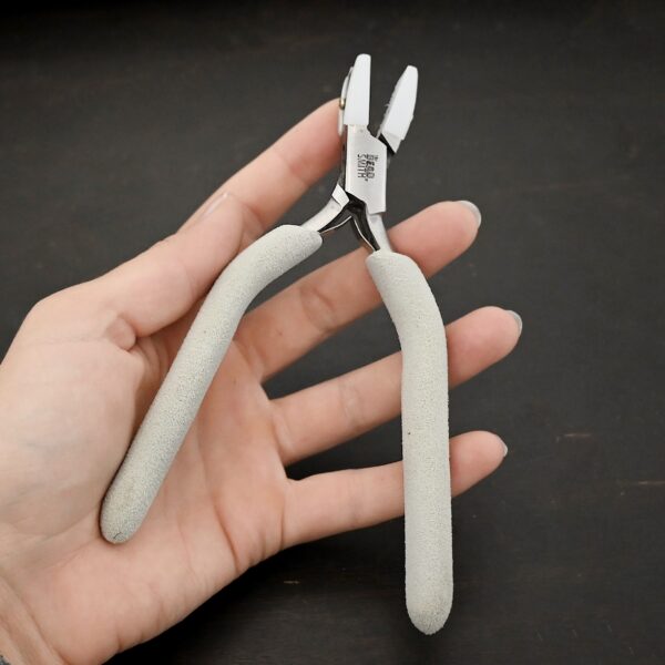 Nylon Jaw Pliers included in kit - stainless steel and white foam handle shown in hand