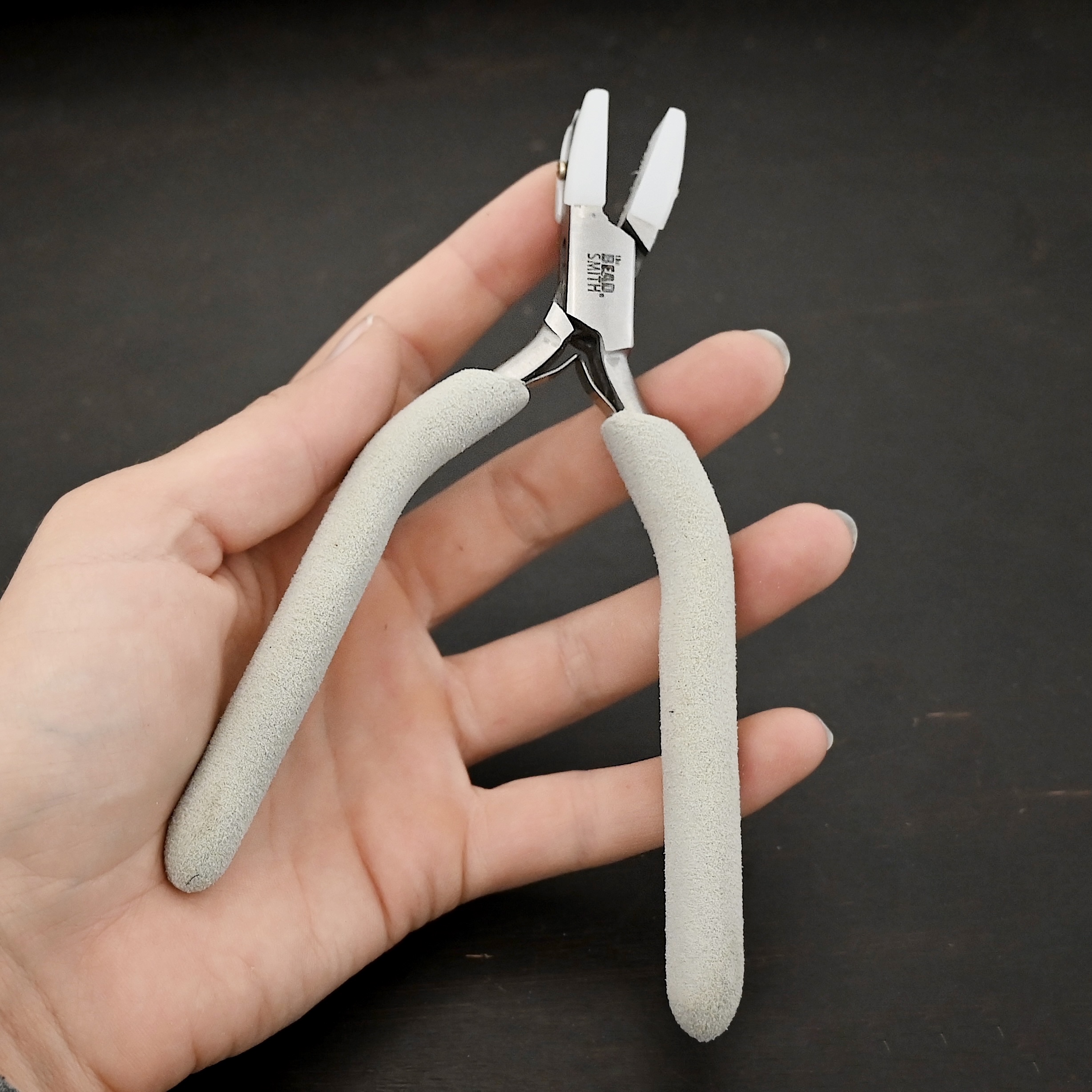 Nylon Jaw Pliers included in kit - stainless steel and white foam handle shown in hand