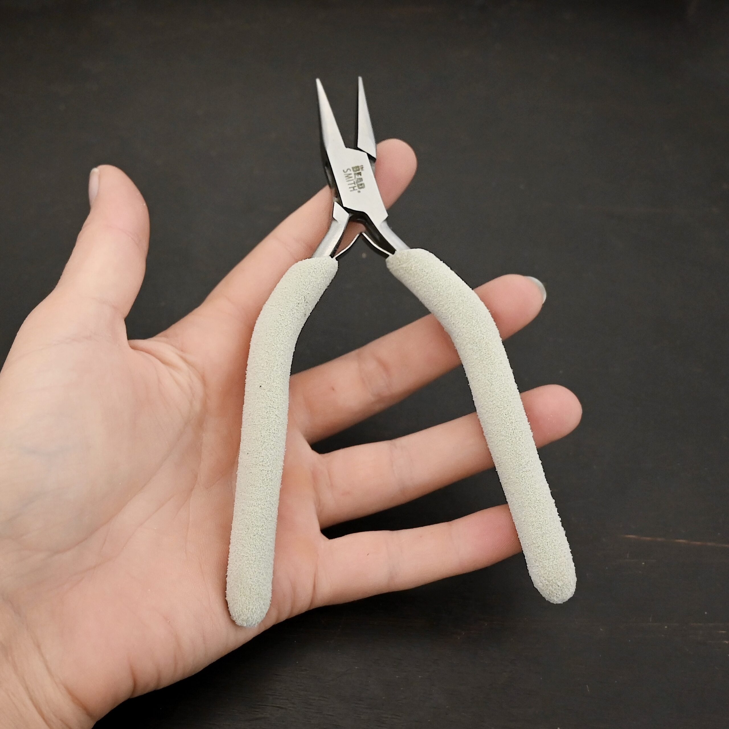Pliers included in kit - stainless steel and white foam handle shown in hand