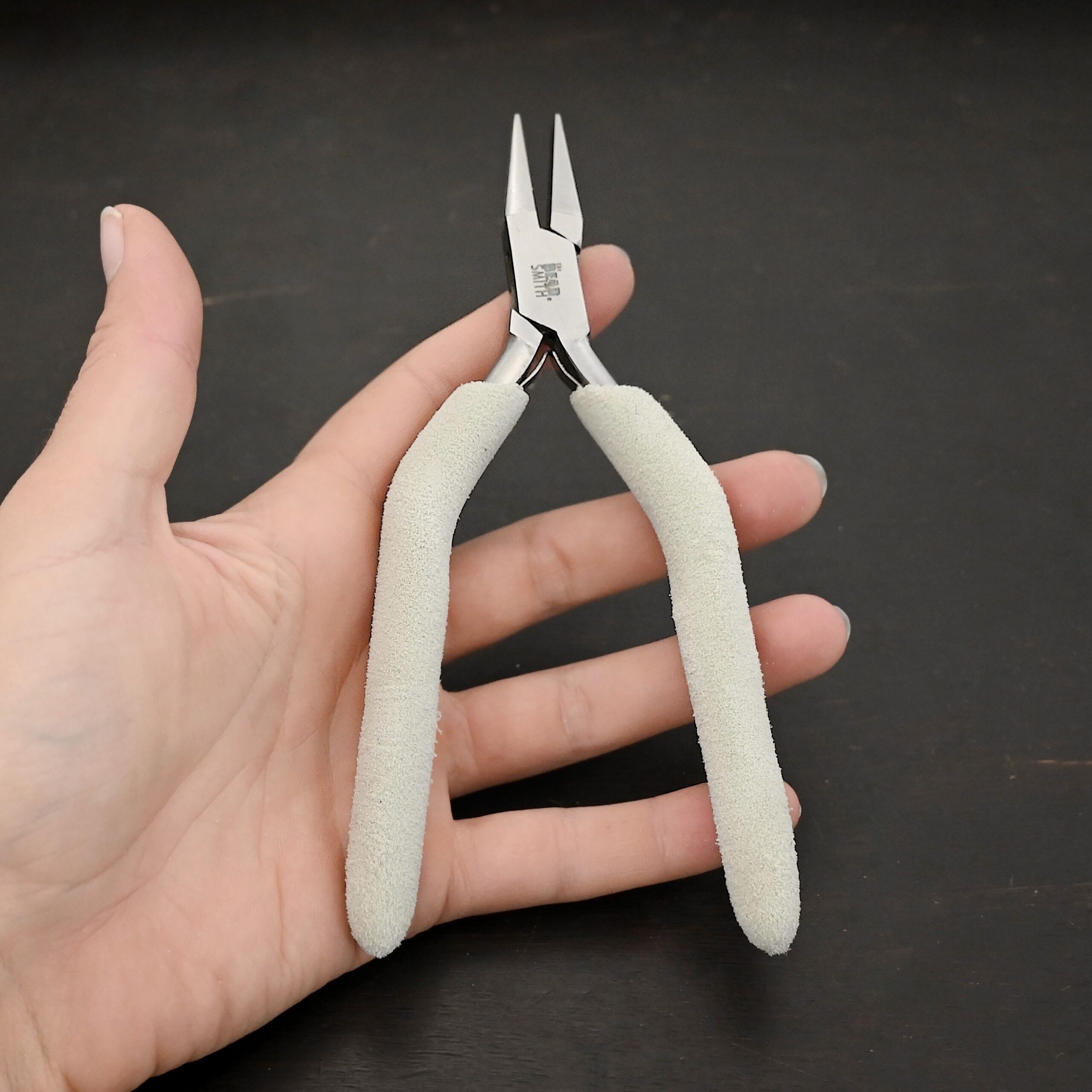 Flat Jaw Pliers included in kit - stainless steel and white foam handle shown in hand