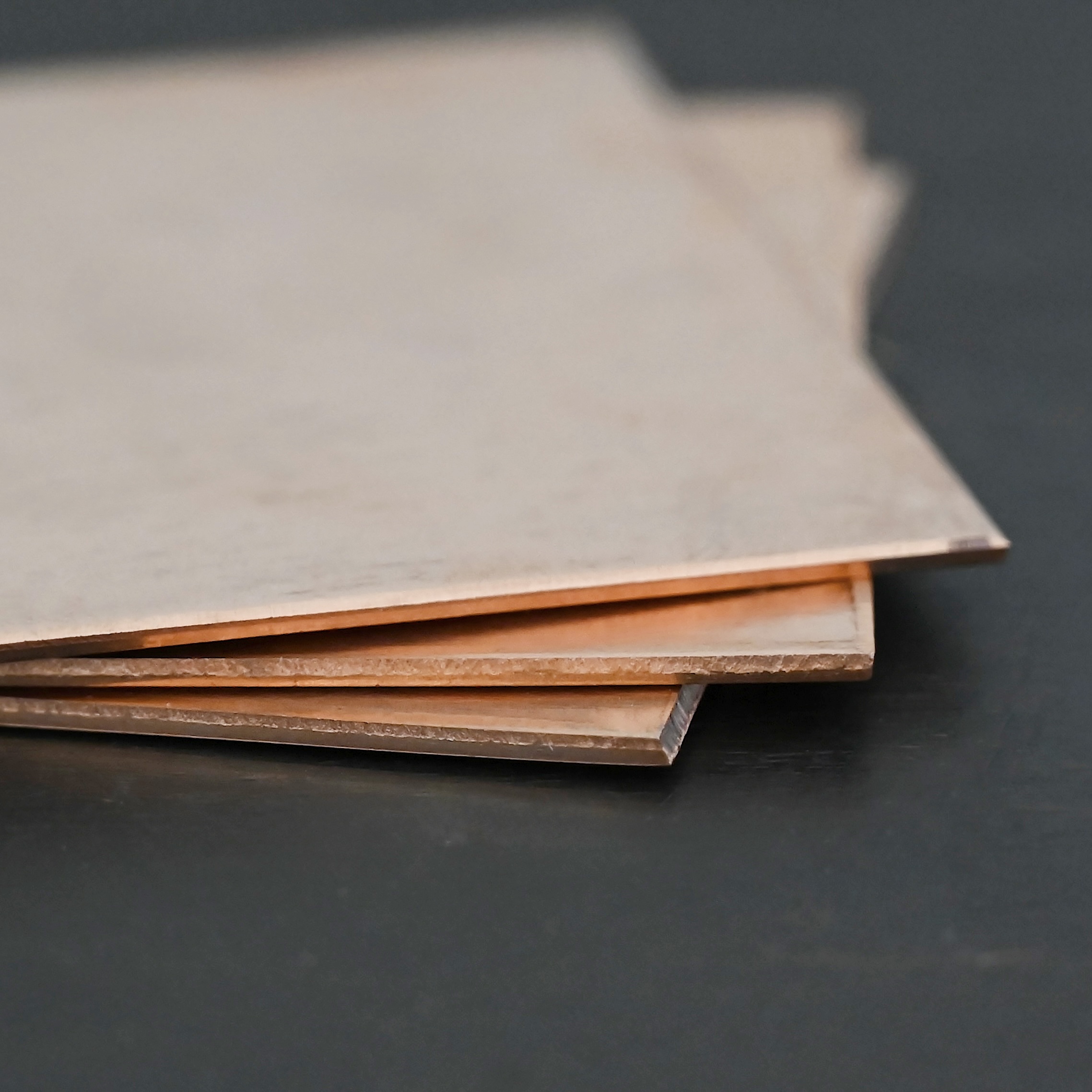 Copper Sheet 3 Copper square sheets shown on dark background