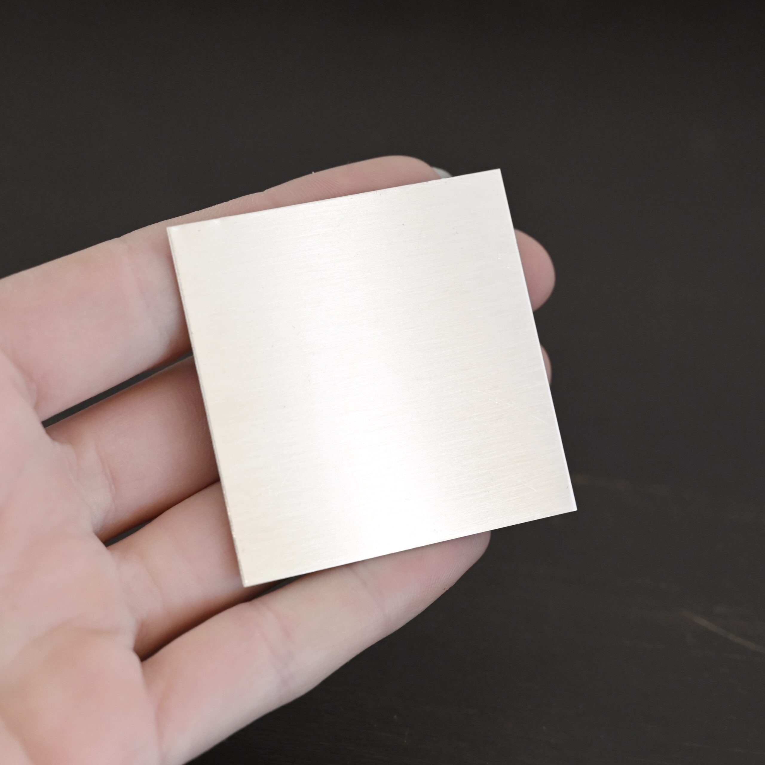 2"x2" silver square sheet shown in hand