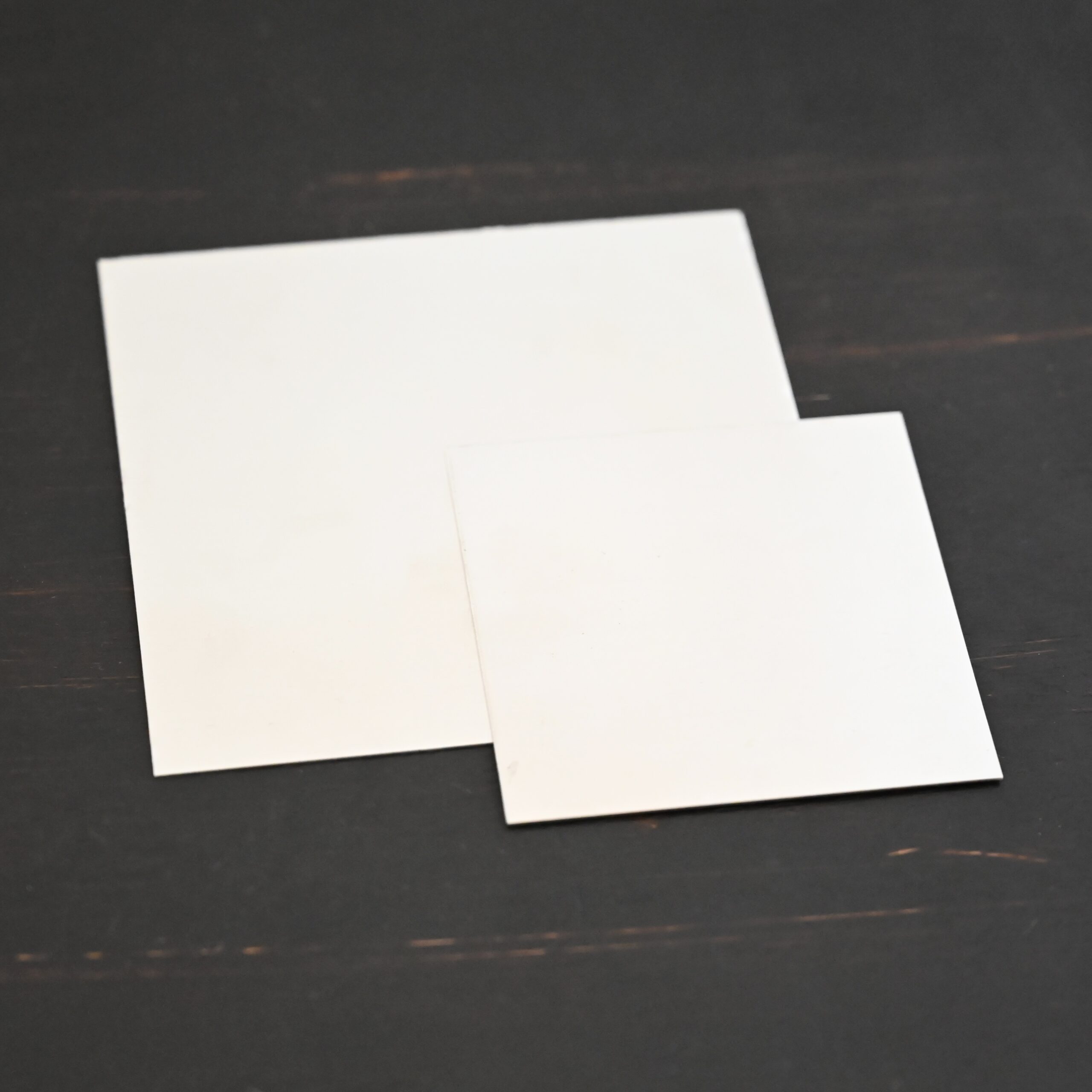 3x3" & 2"x2" silver square sheet shown on dark background