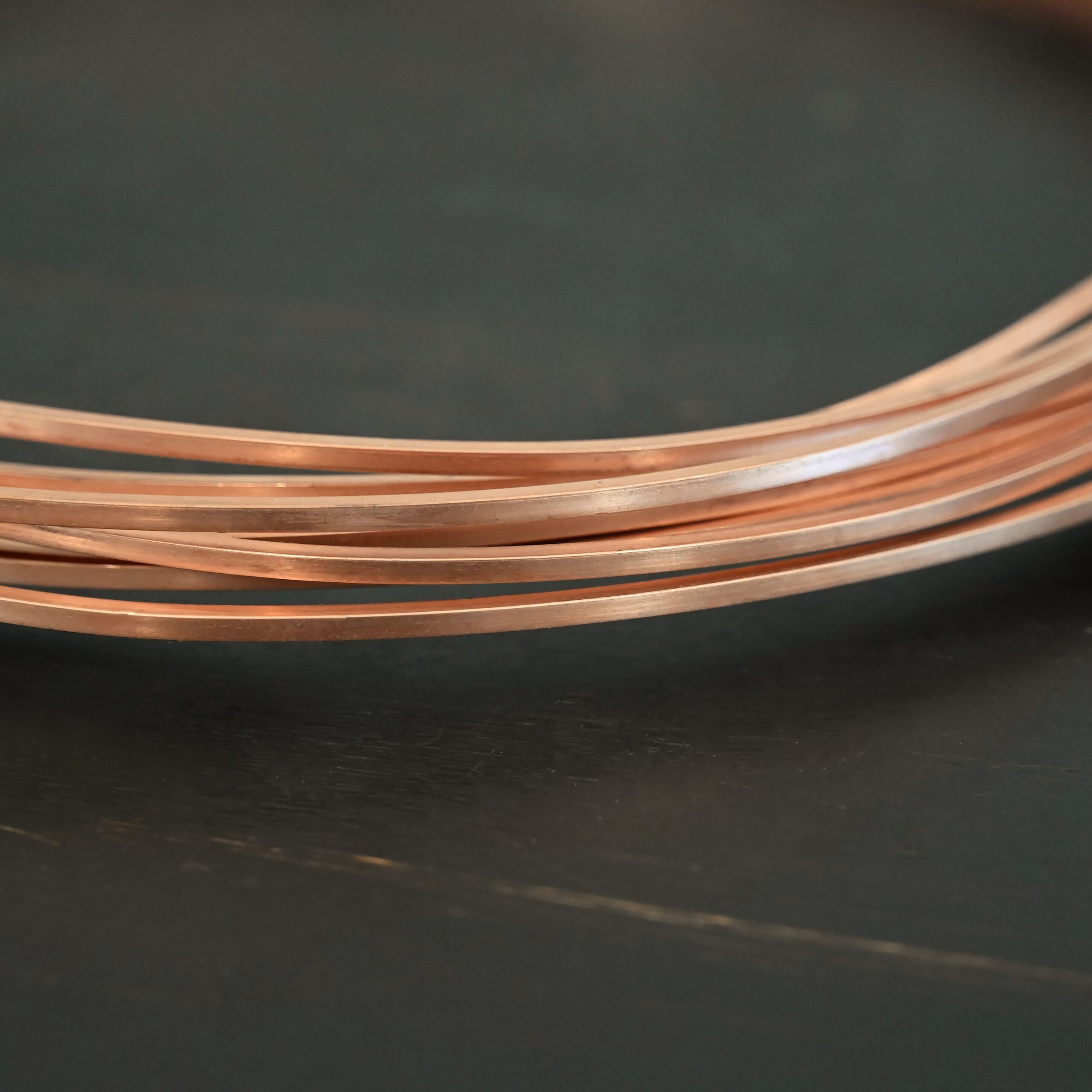 Copper Square Wire Copper Square Wire shown on dark background