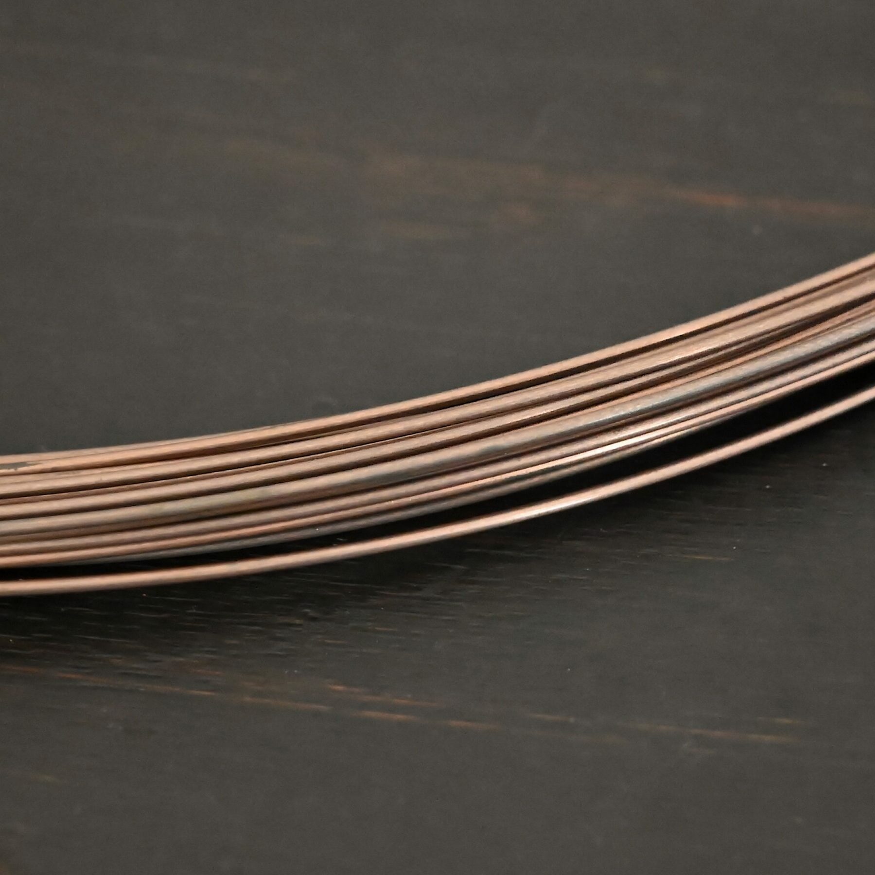 Copper Solder Wire shown on dark background