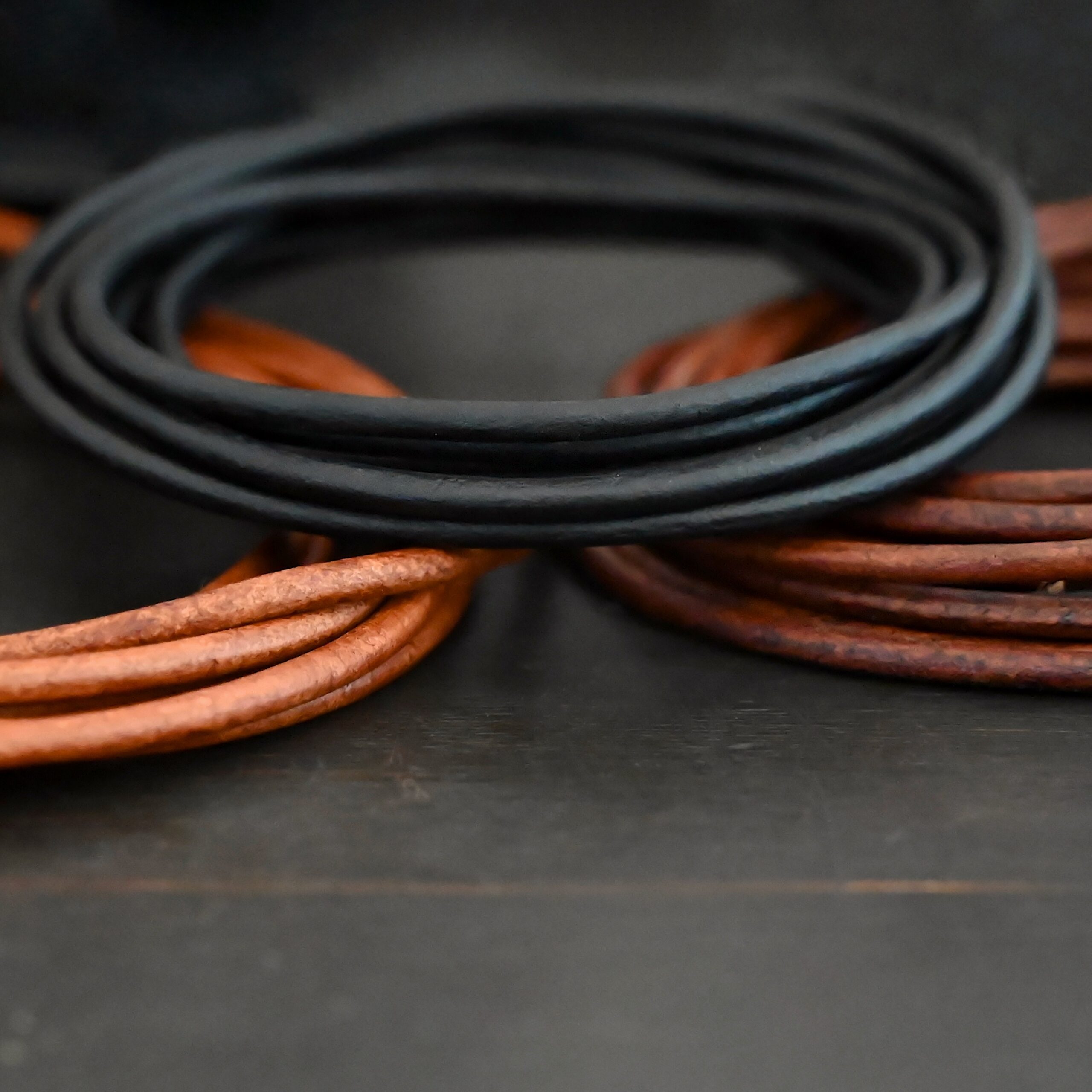 Genuine Natural Leather Black, light brown, dark brown on dark background