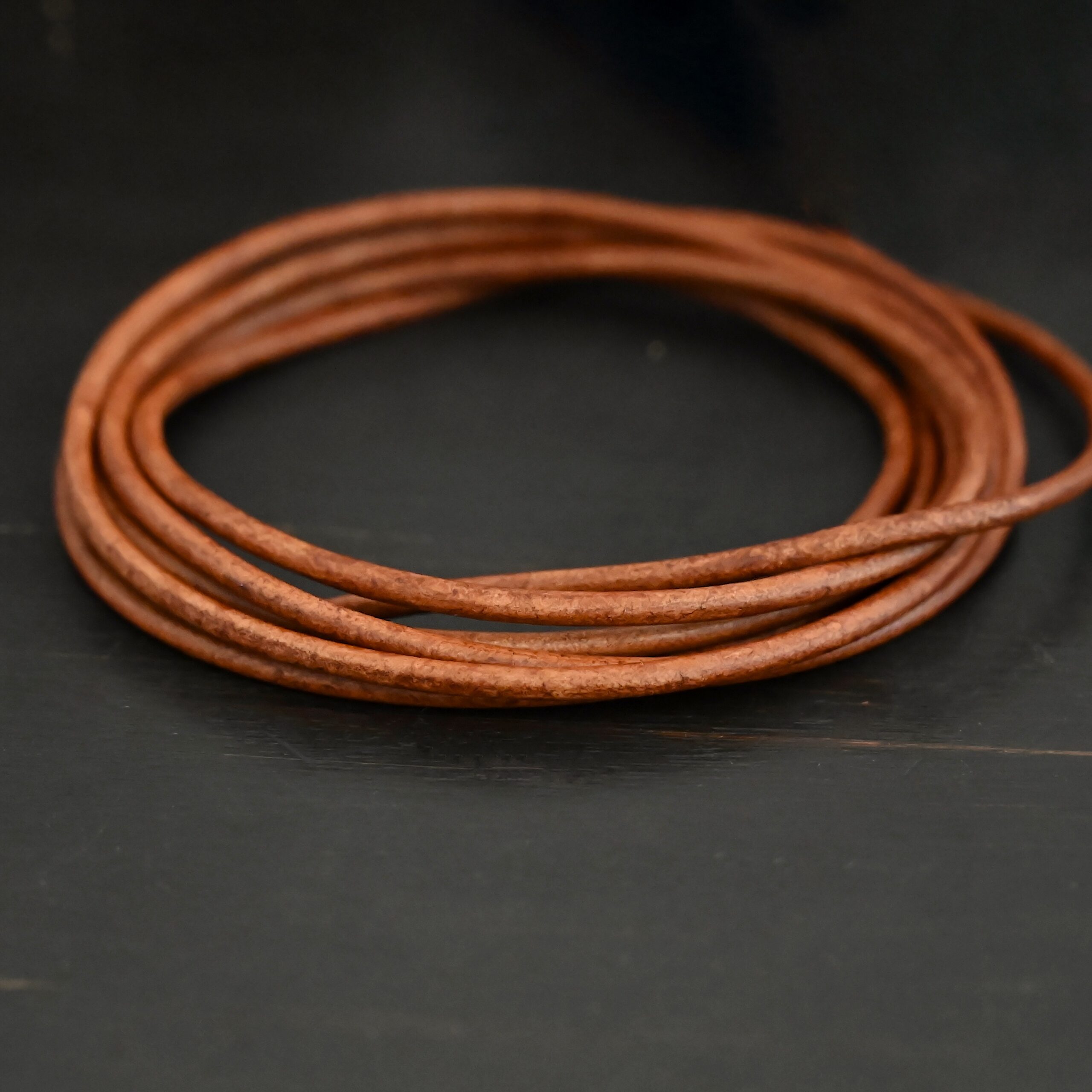 Genuine Natural 3mm light brown leather on dark background