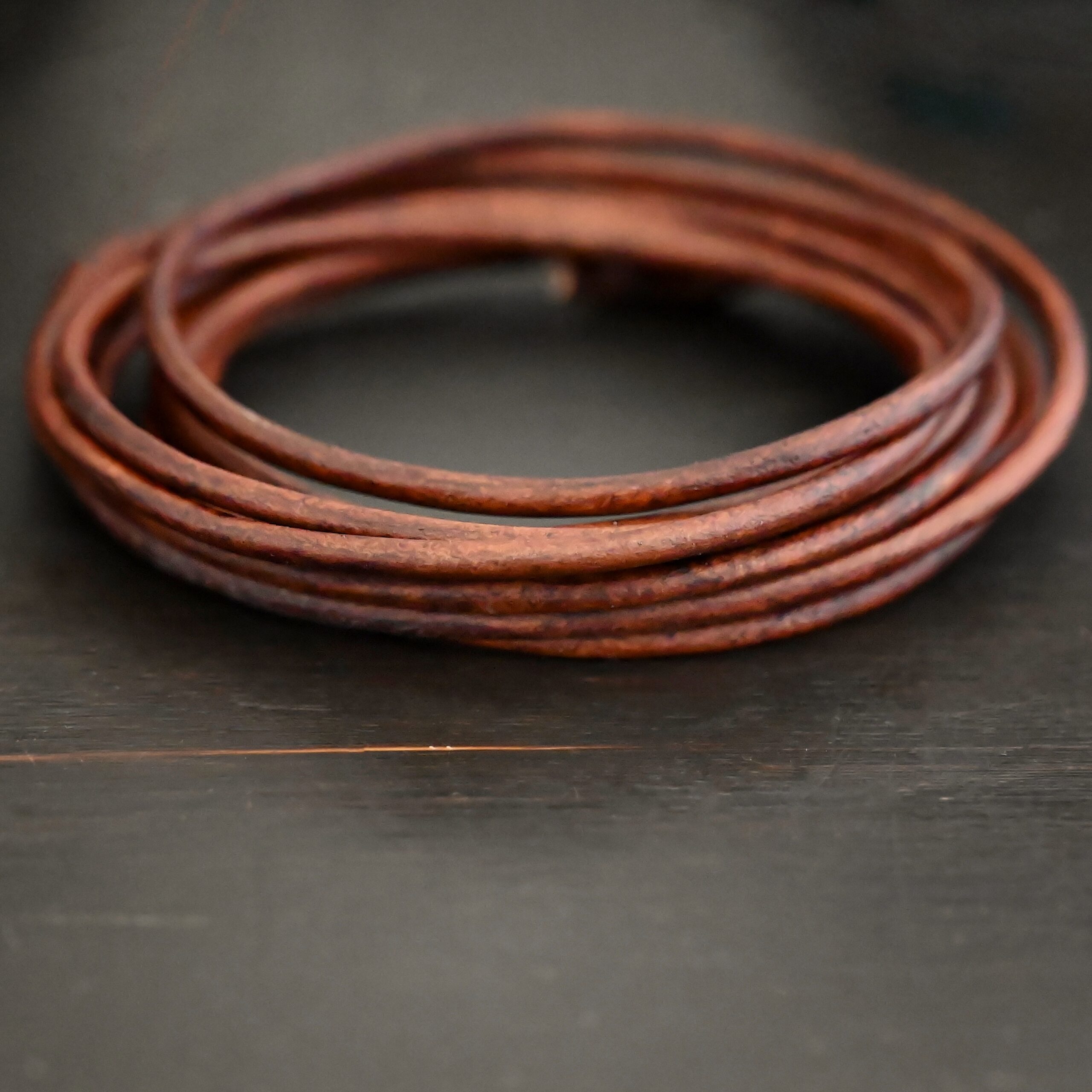 Genuine Natural 3mm antique brown leather on dark background