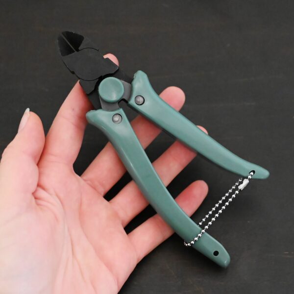 Power Max Full Flush Cutting Pliers - Turquoise plastic handle shown in hand