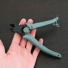 Power Max Full Flush Cutting Pliers - Turquoise plastic handle shown in hand