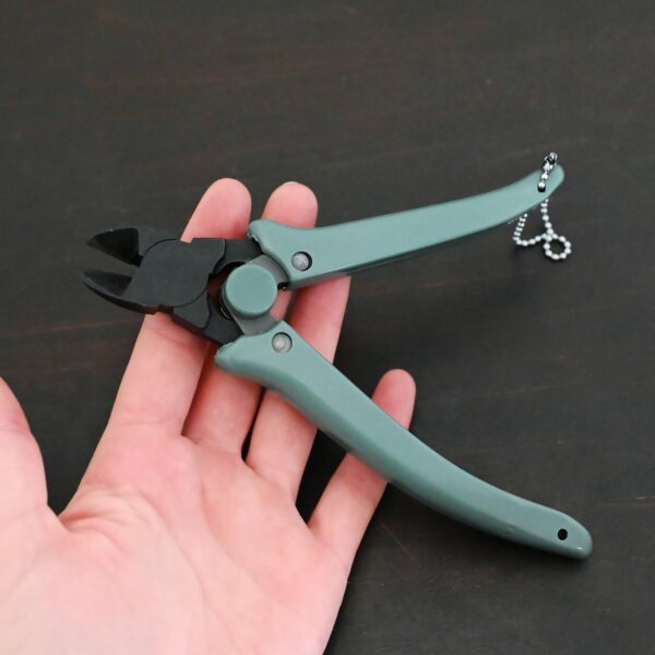 Power Max Full Flush Cutting Pliers - Turquoise plastic handle shown in hand