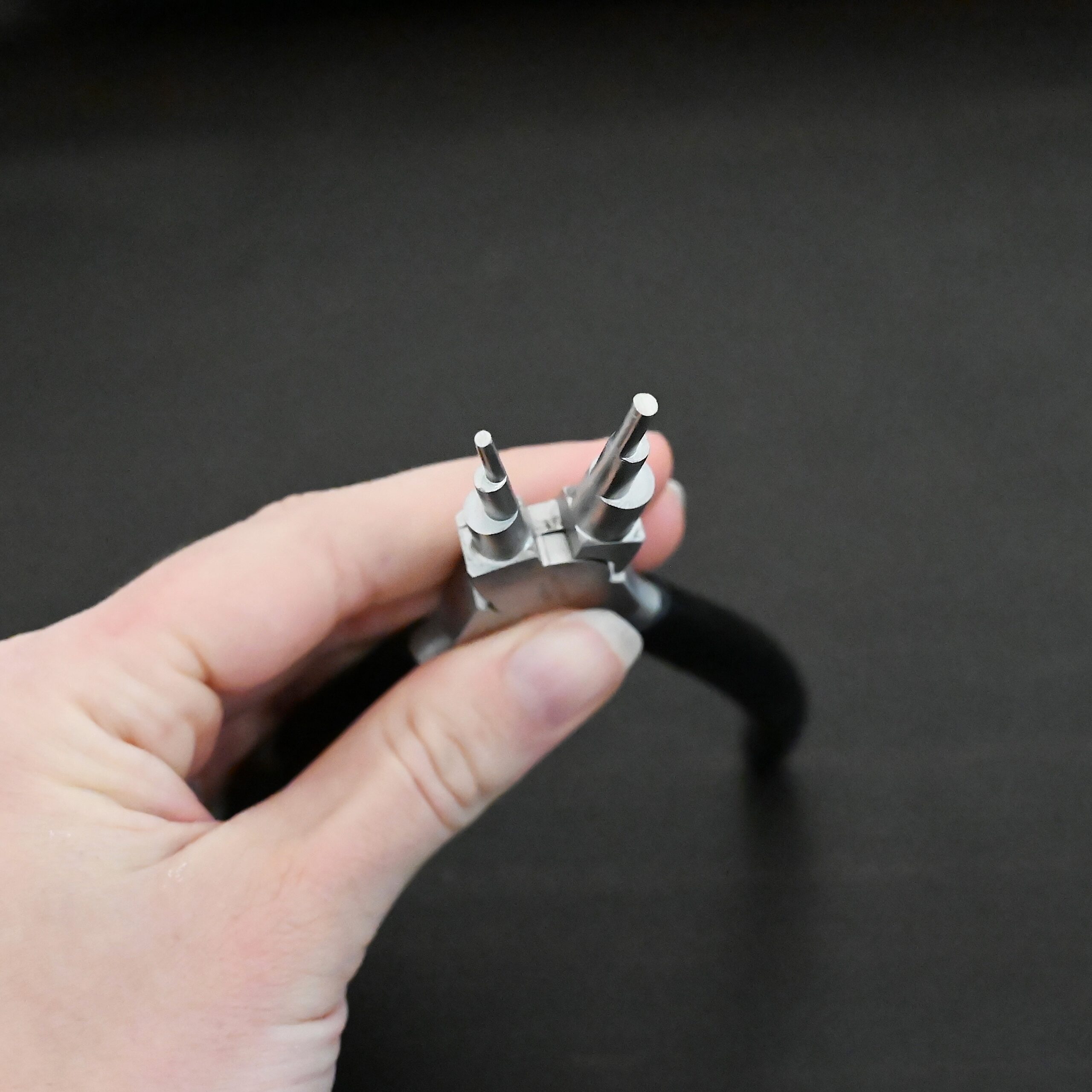 Double Stepped Mandrel Pliers - Black rubber handle shown in hand