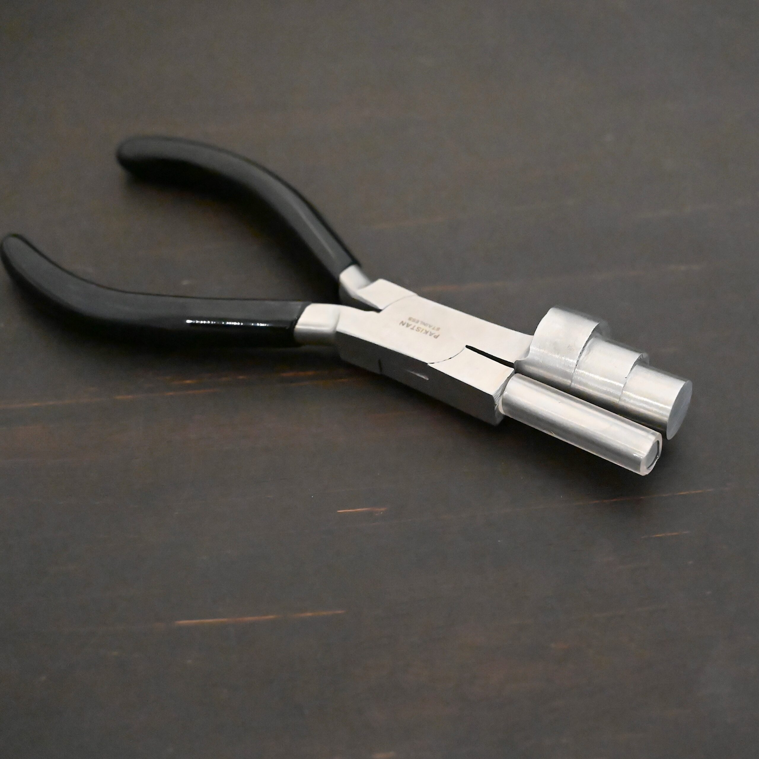 XL Stepped Mandrel Pliers - Black rubber handle shown on dark background