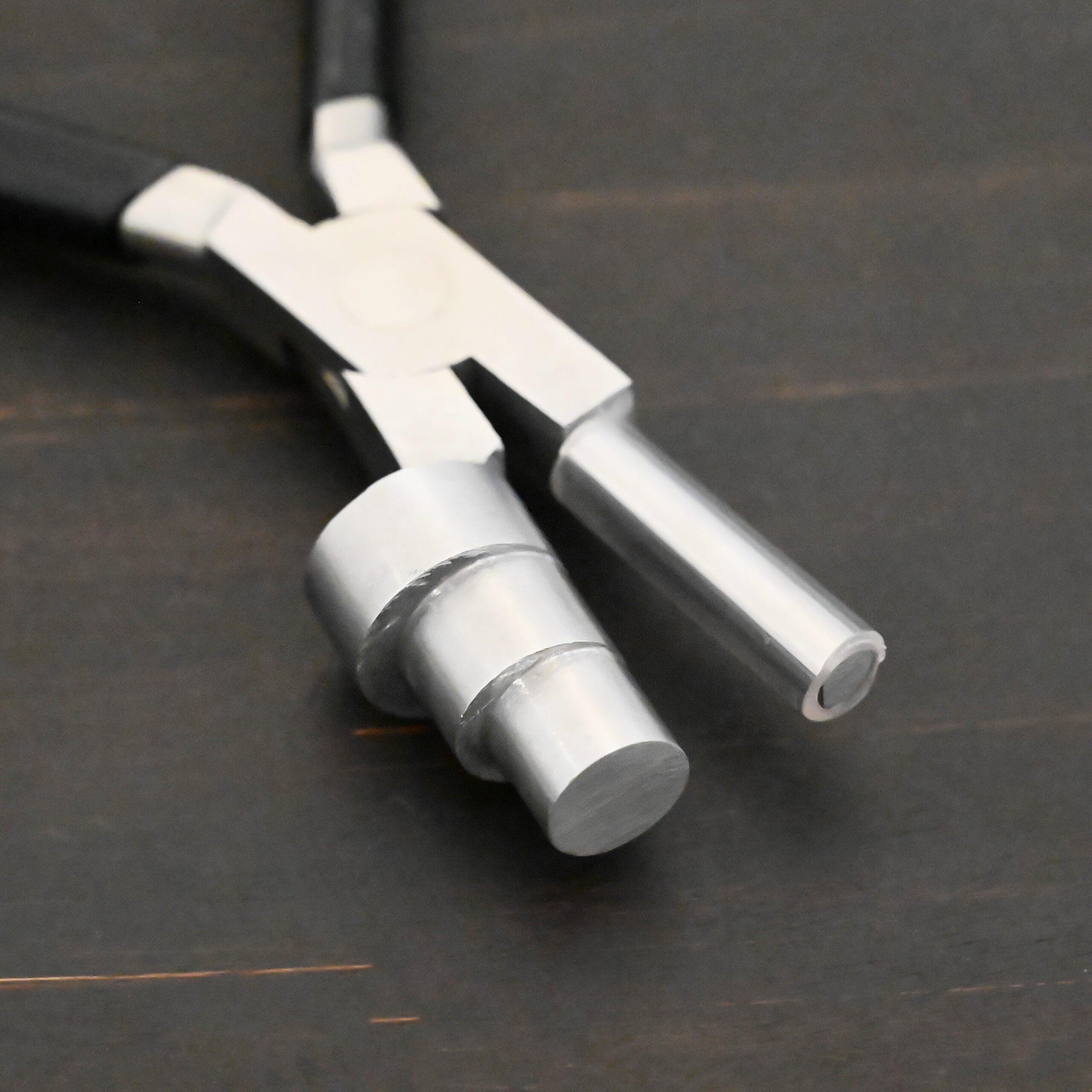 XL Stepped Mandrel Pliers - Black rubber handle shown on dark background