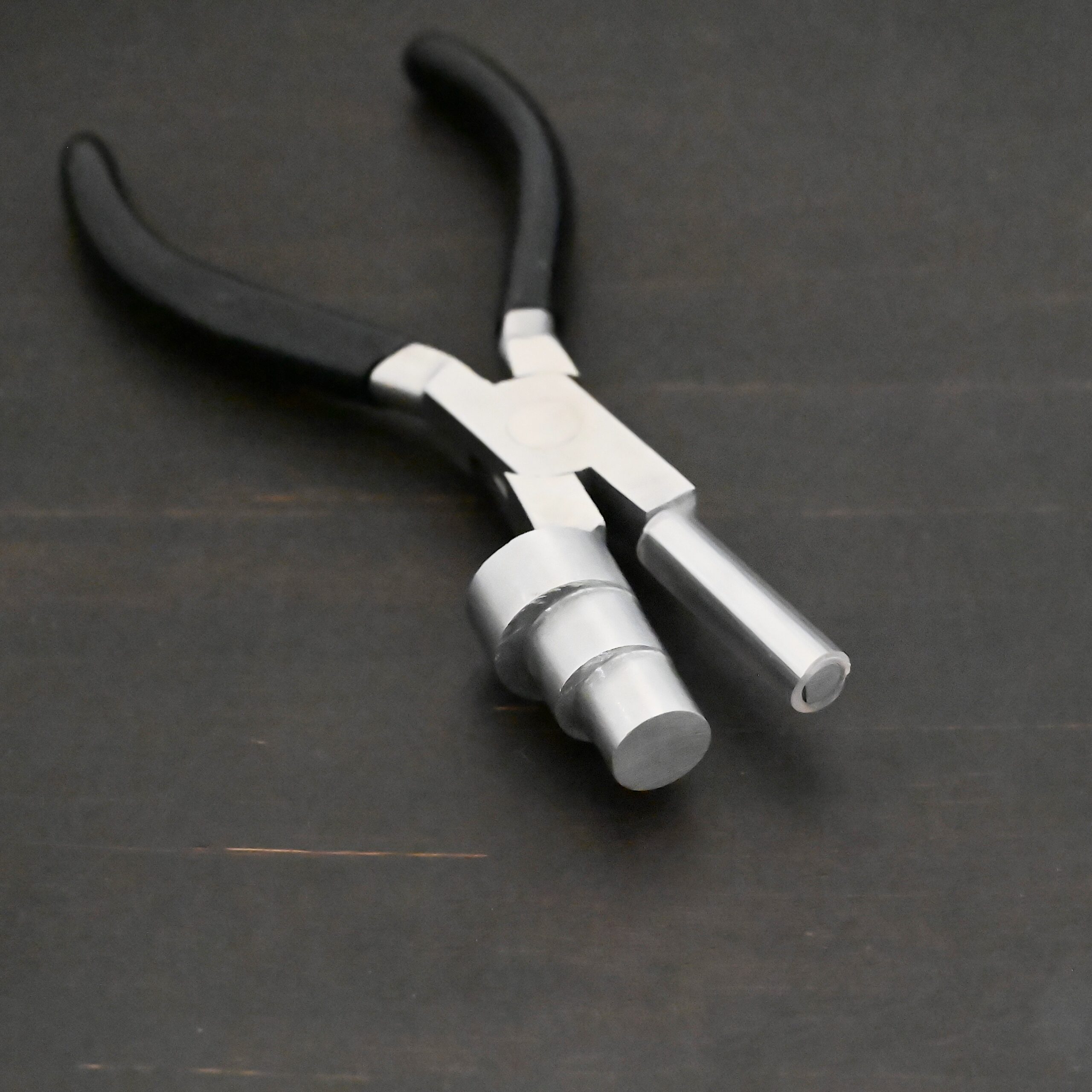 XL Stepped Mandrel Pliers - Black rubber handle shown on dark background