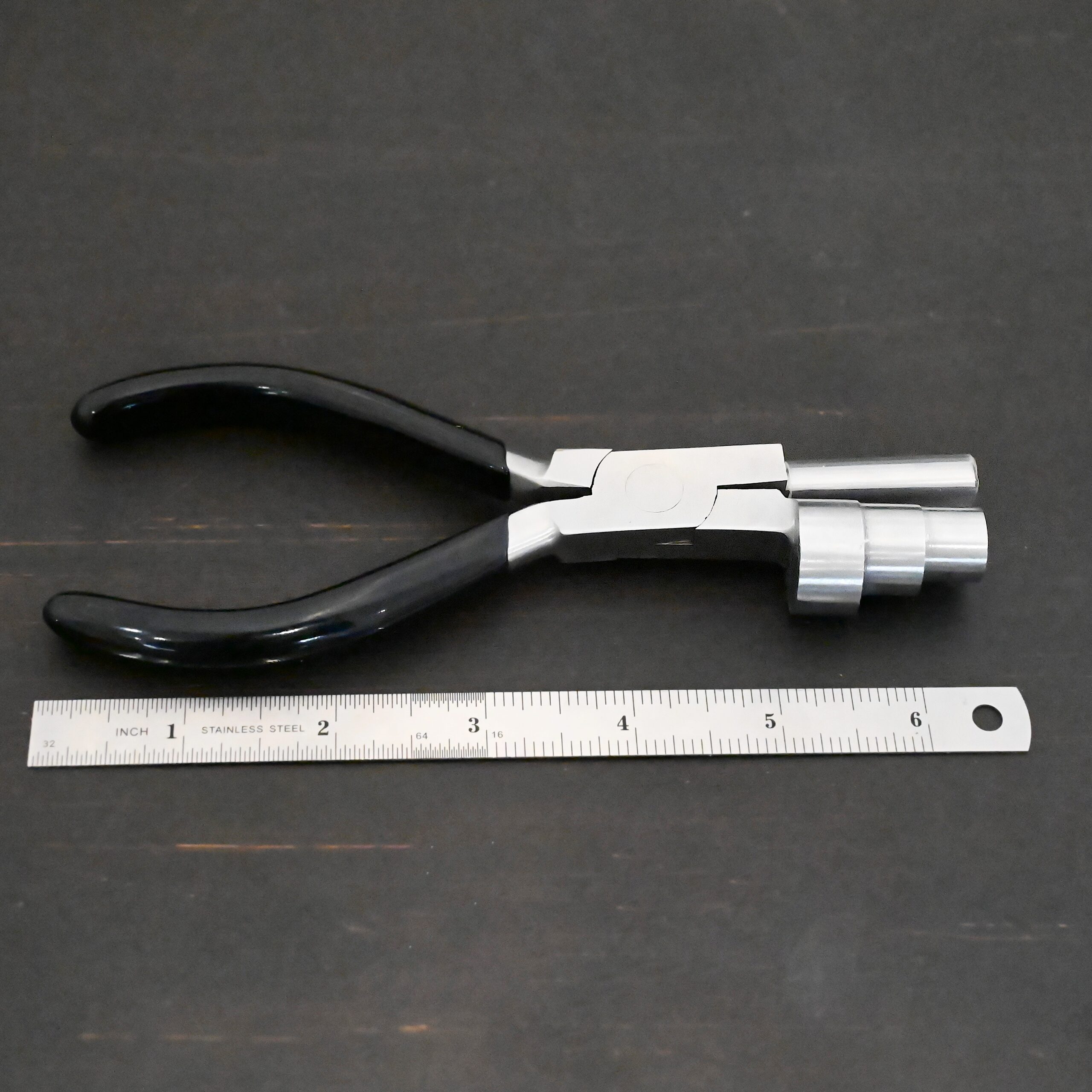 XL Stepped Mandrel Pliers - Black rubber handle shown next to ruler