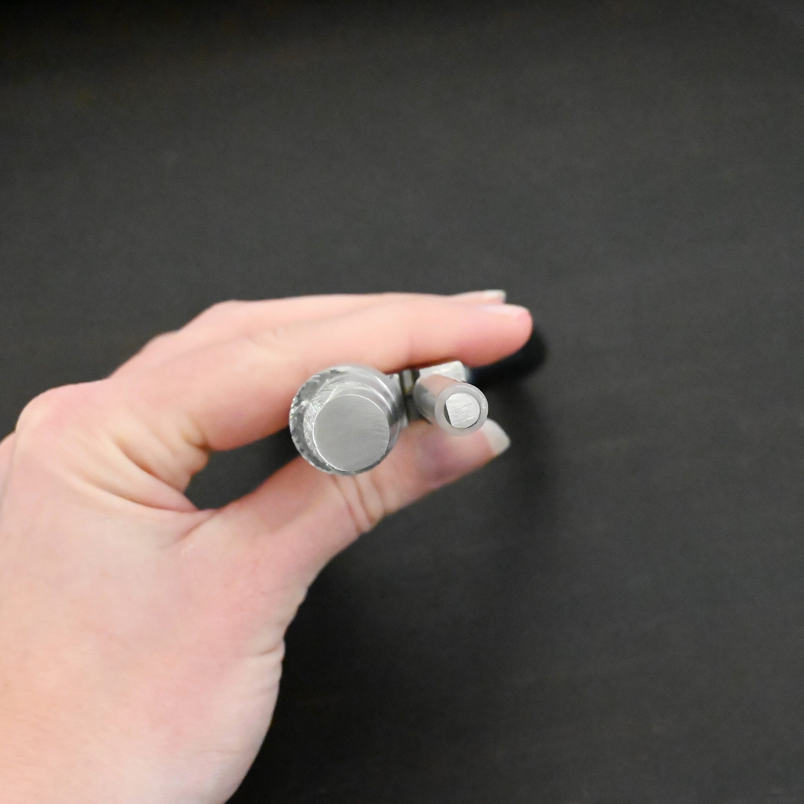 XL Stepped Mandrel Pliers - Black rubber handle shown in hand