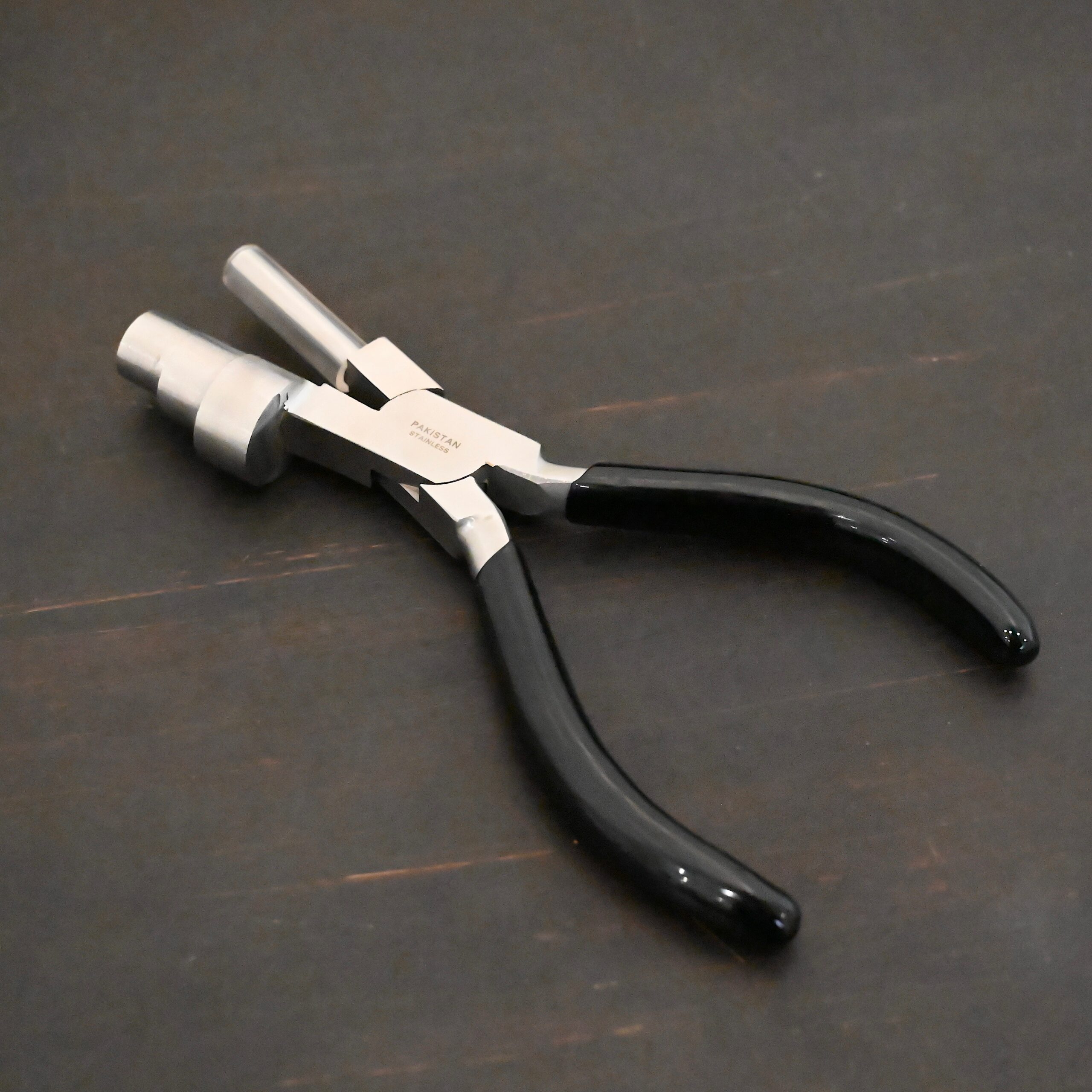 XL Stepped Mandrel Pliers - Black rubber handle shown on dark background