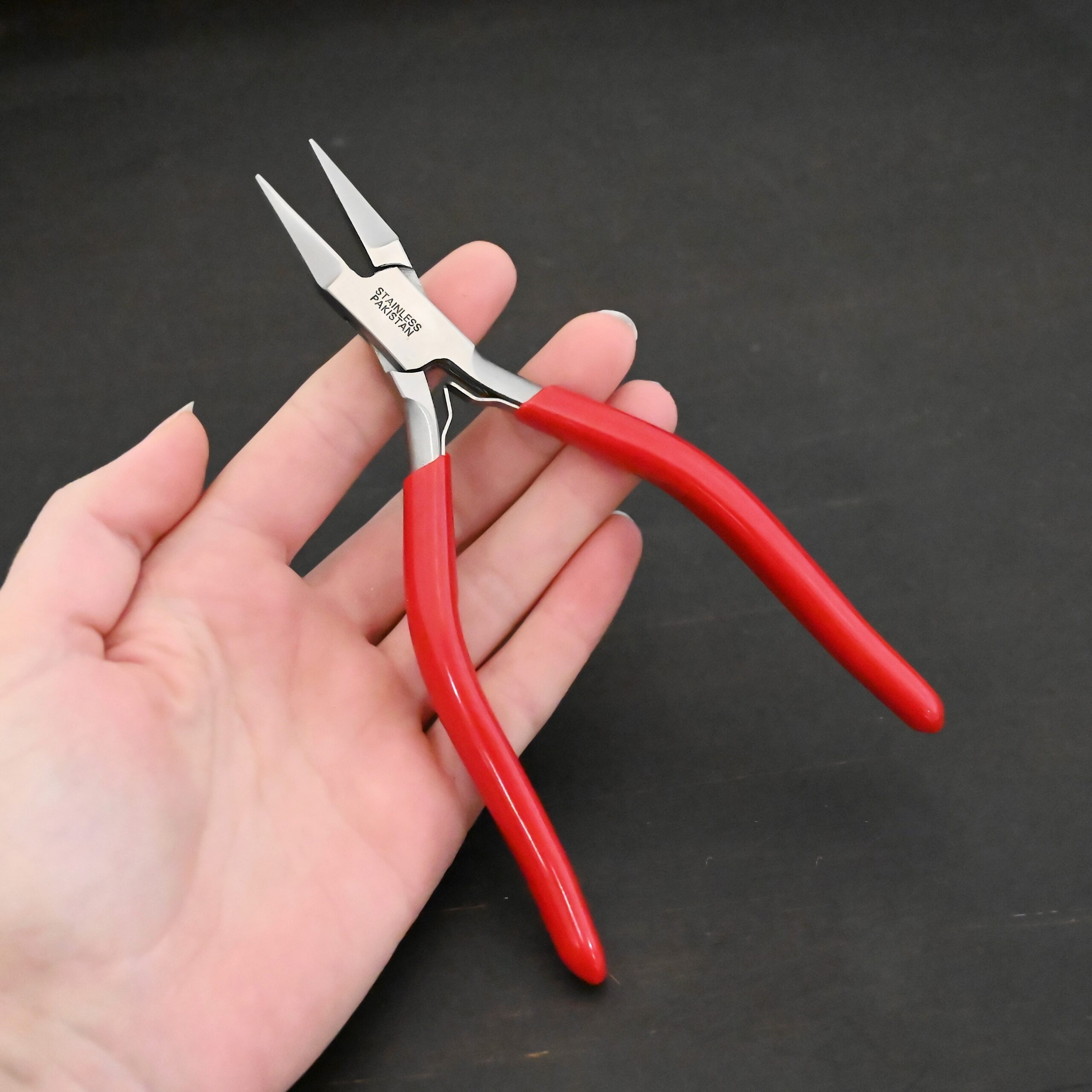 Flat Jaw Pliers - Red rubber handle shown in hand