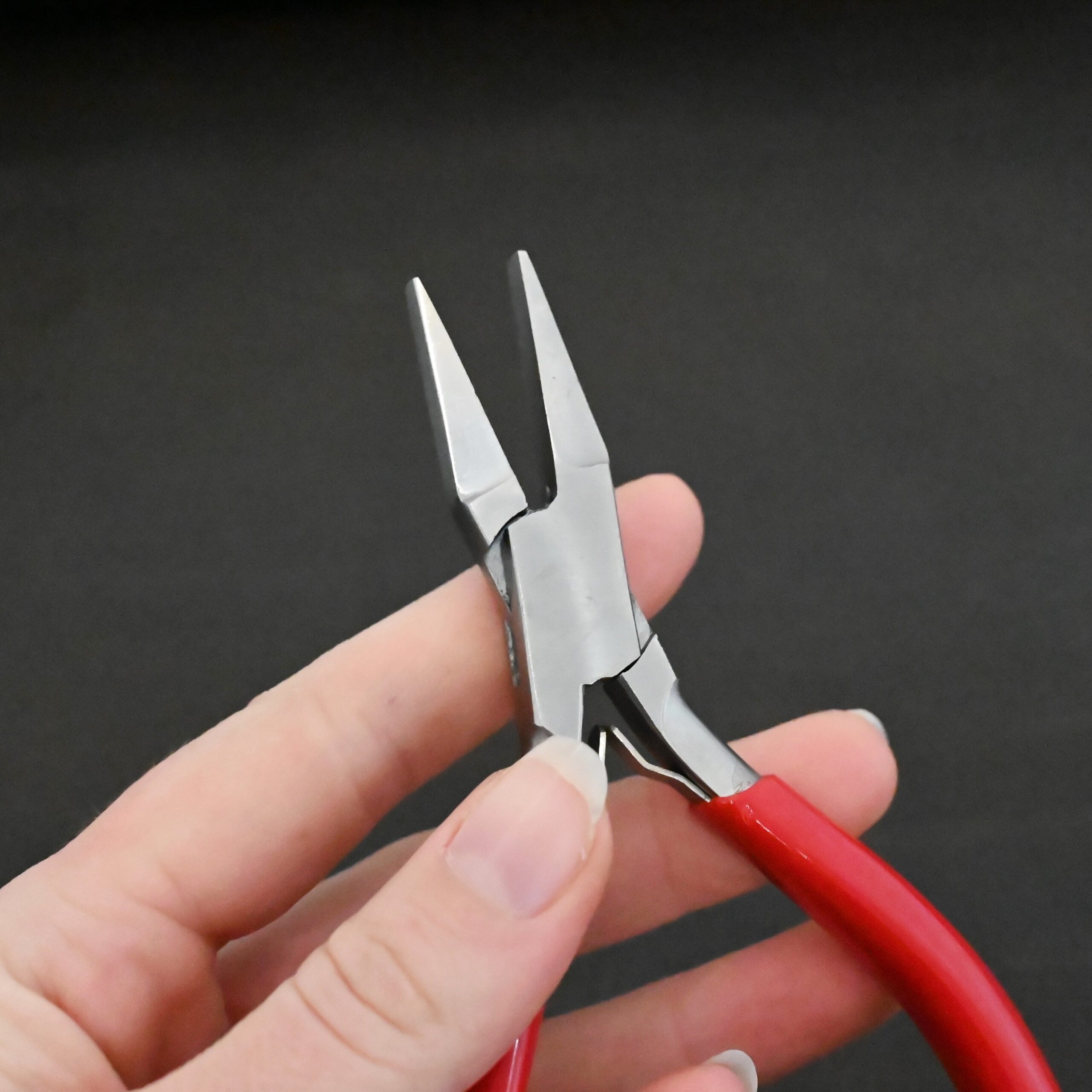 Flat Jaw Pliers - Red rubber handle shown in hand